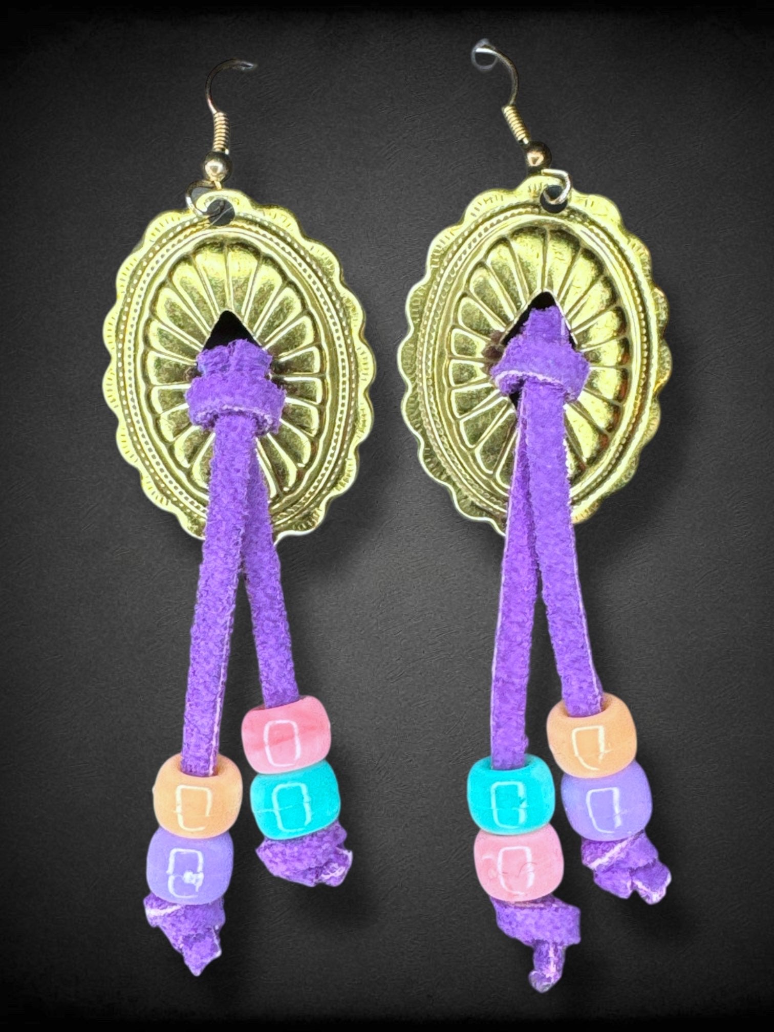 Gold tone metal and purple ties with plastic beads