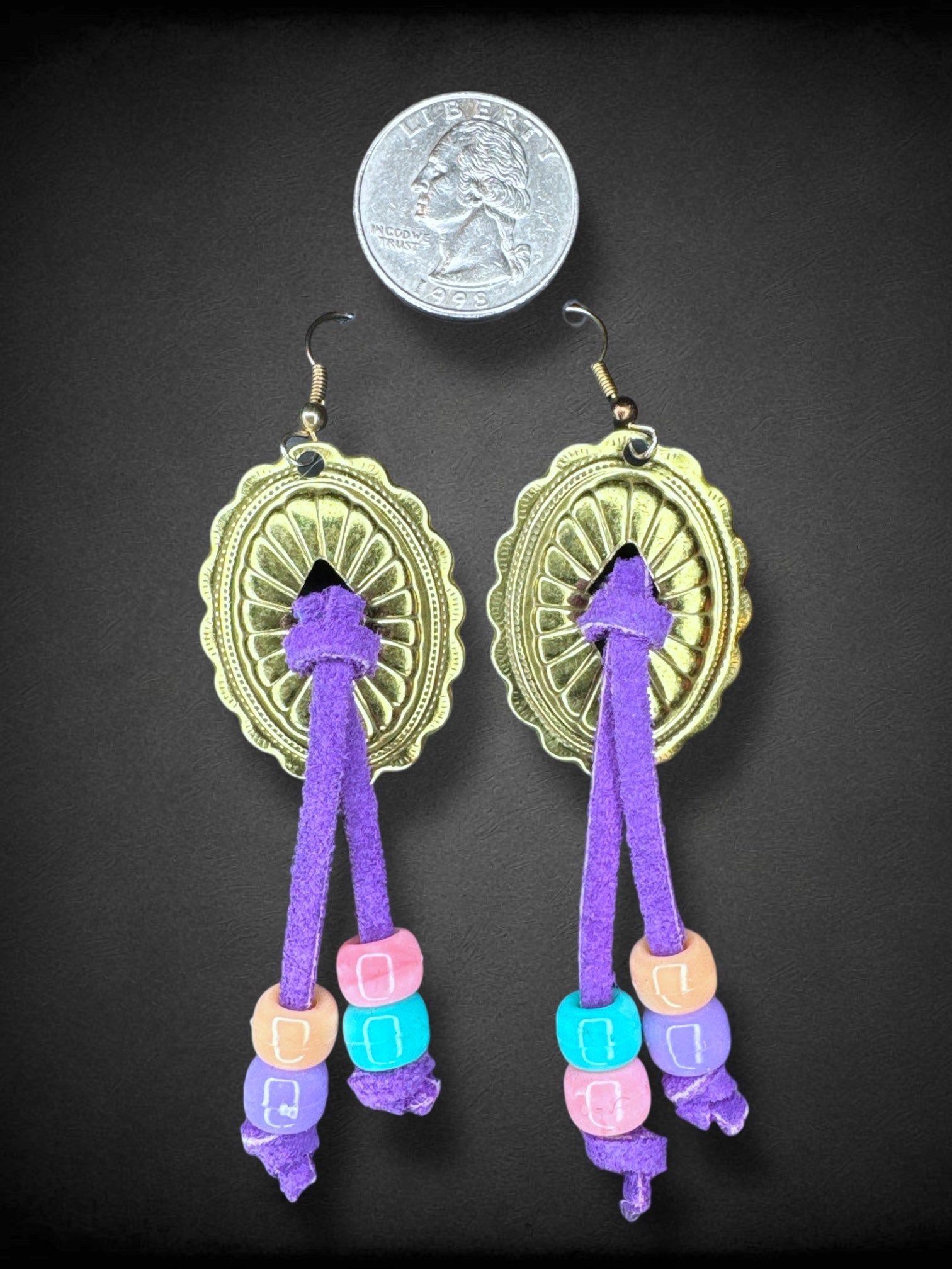 Gold tone metal and purple ties with plastic beads