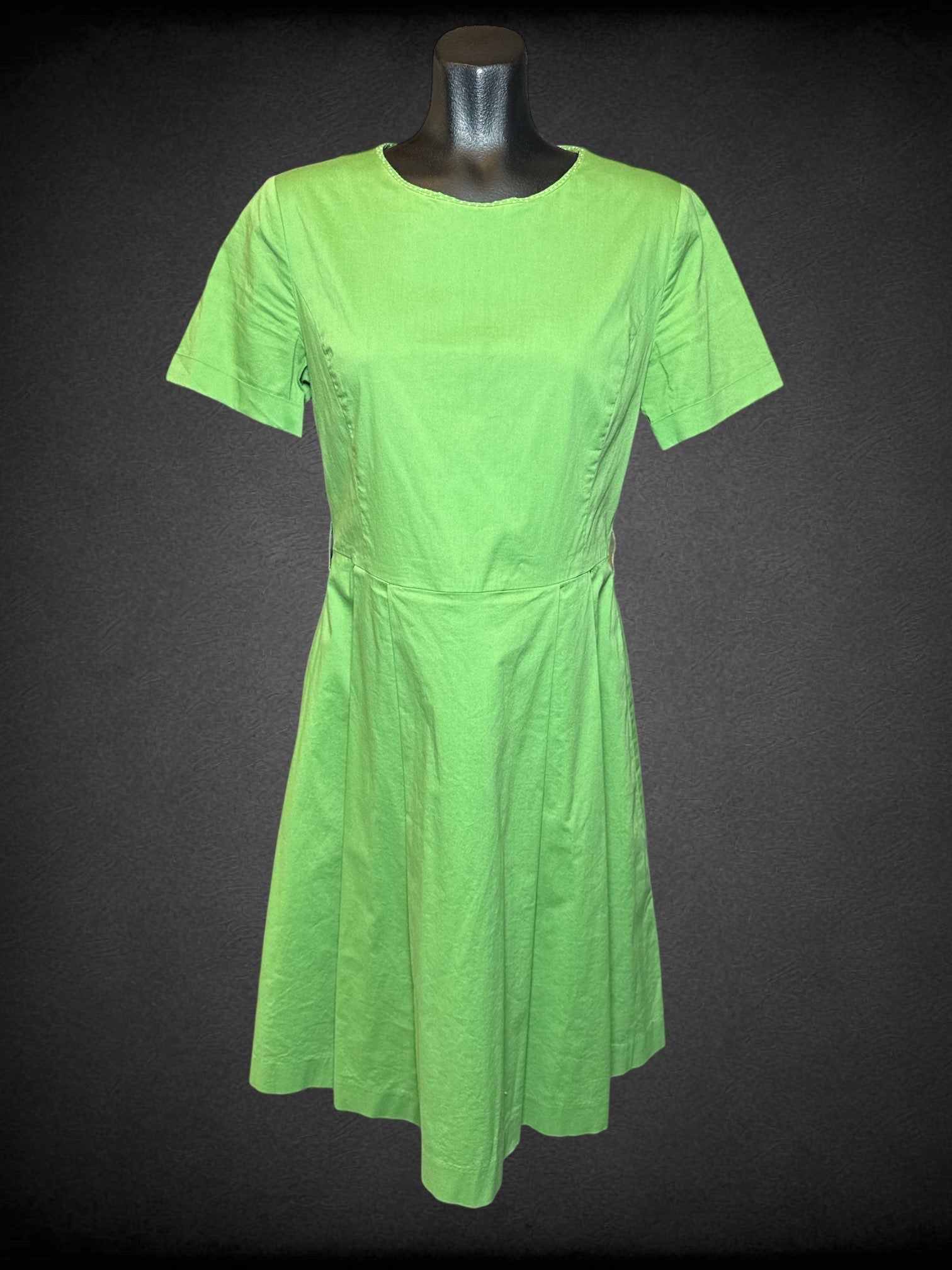 M Osborne green short sleeve dress with zipper on back, and white polka dots on neckline
