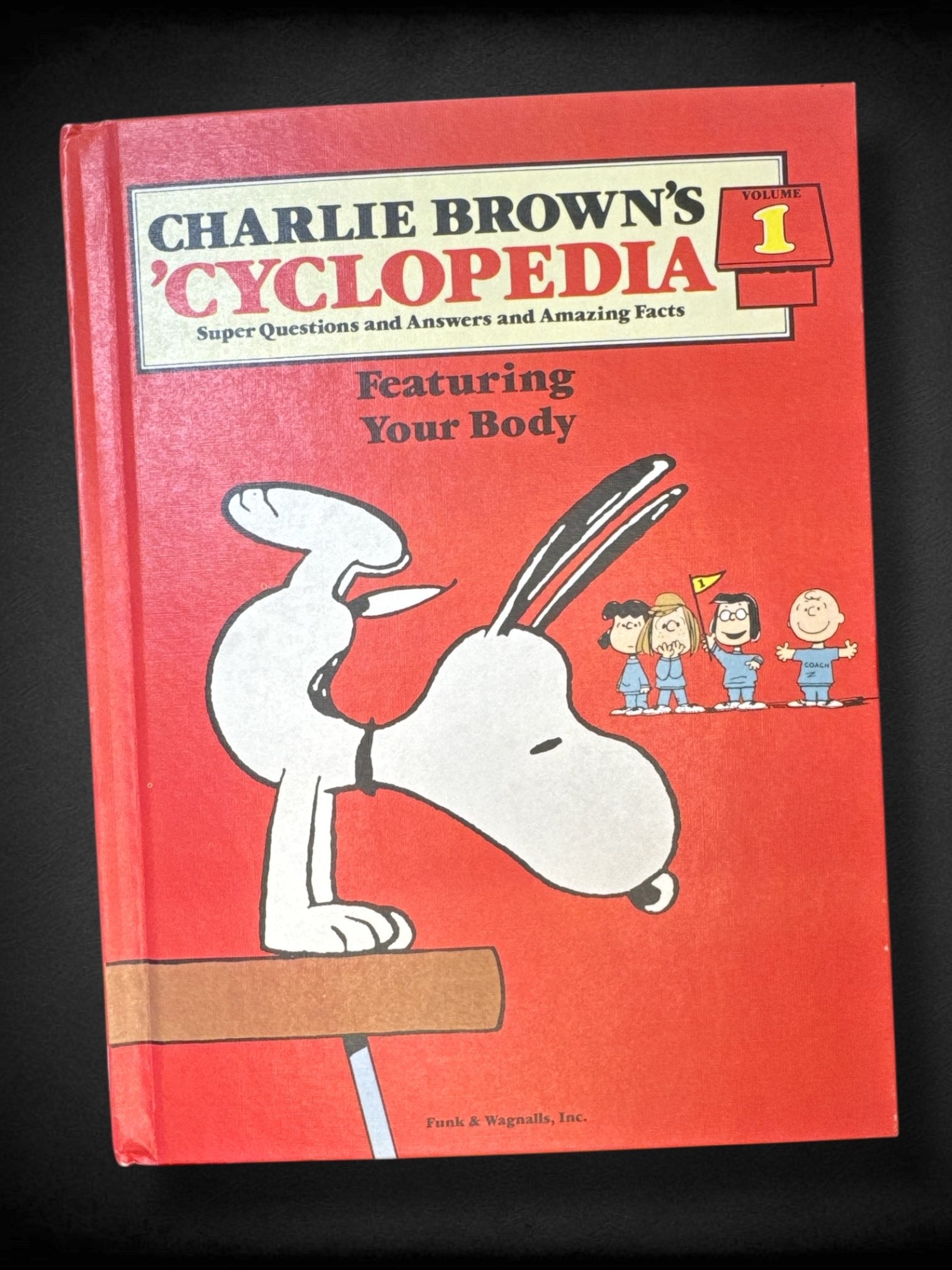 Bundle of 2 Peanuts cartoon books. Contains “Charlie Brown’s ‘Cyclopedia: Featuring Your Body” and “Let’s Fly a Kite, Charlie Brown!” Little golden book