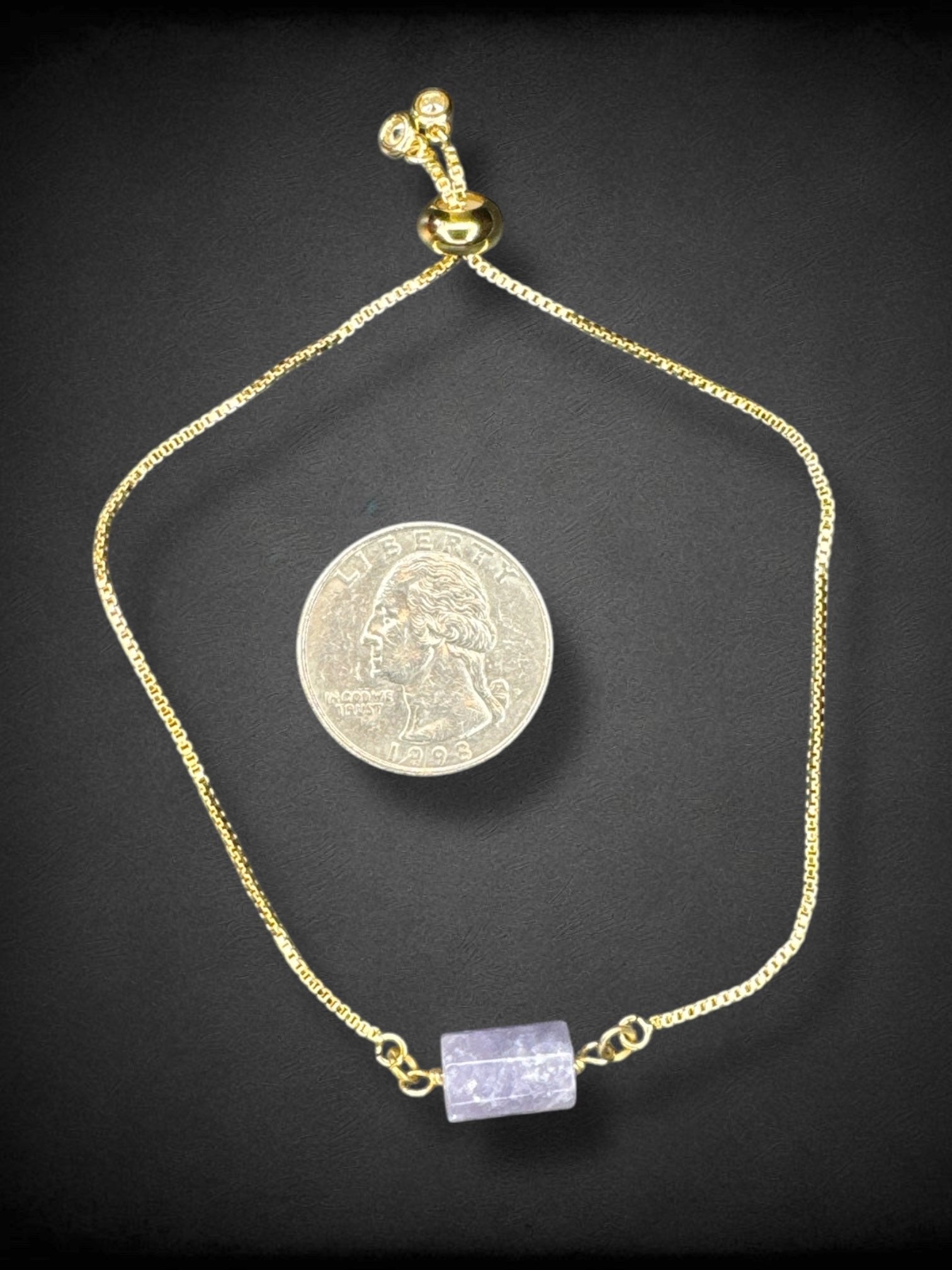 5” gold tone drawstring bracelet with purple glass bead