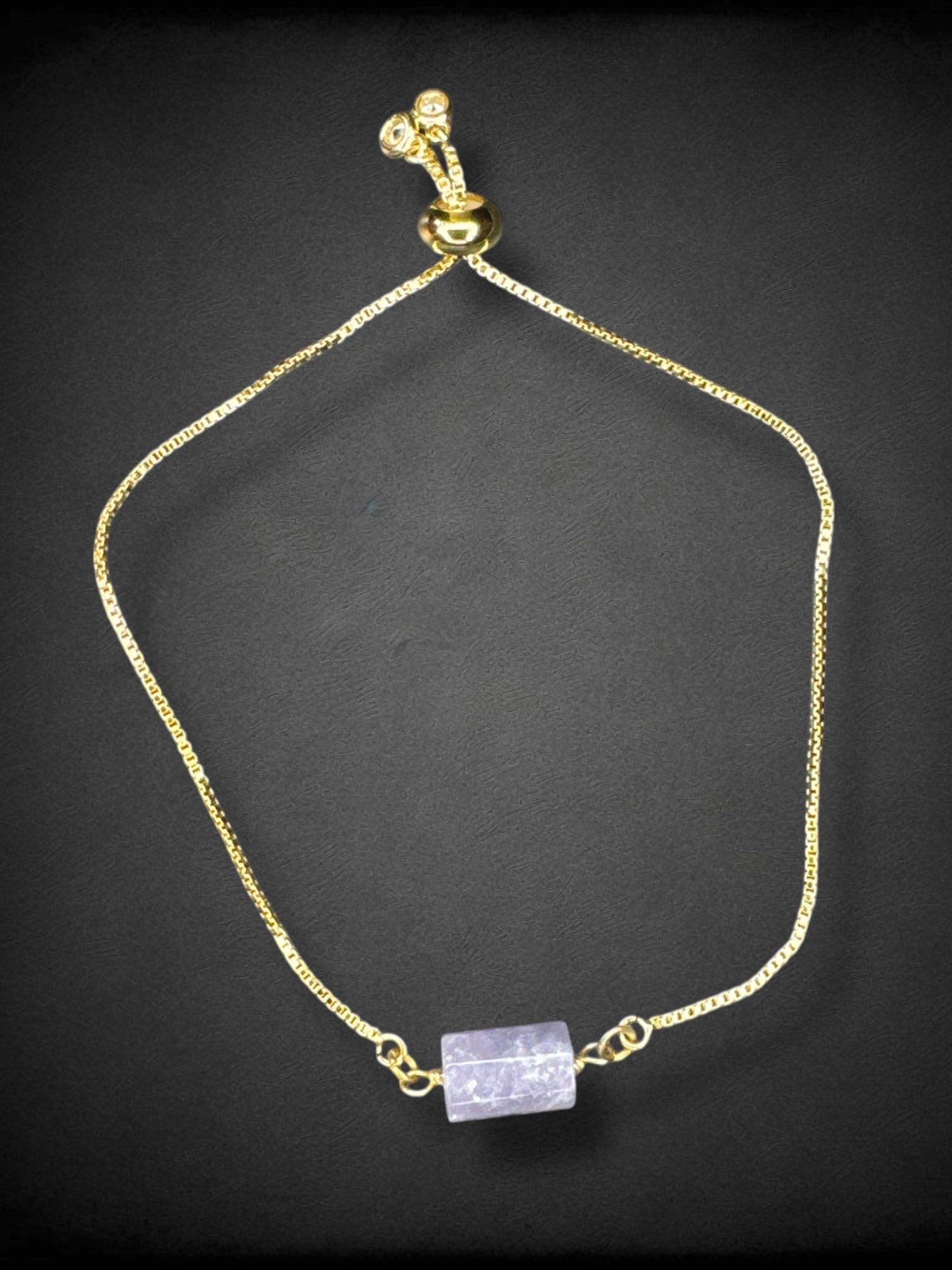 5” gold tone drawstring bracelet with purple glass bead