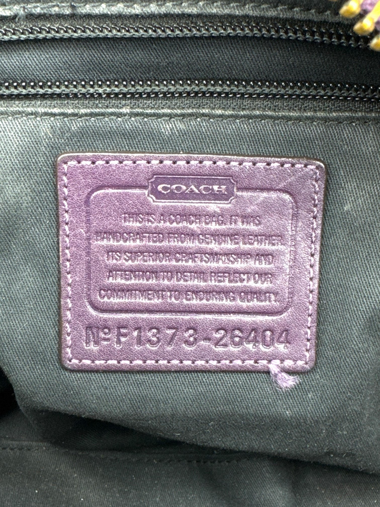 Coach purple leather purse with handles, bronze studding, and large leather tassels on front