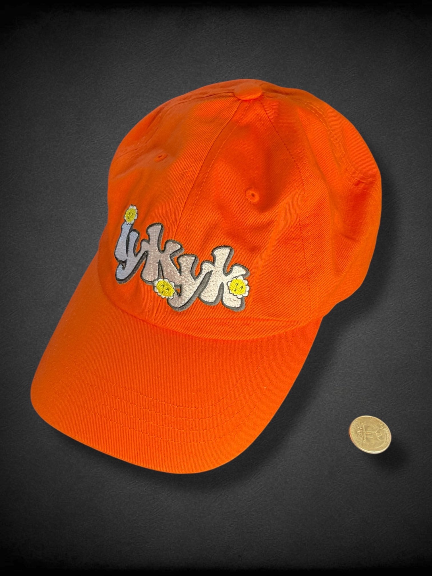Orange “iykyk” groovy text embroidered baseball cap with flowers