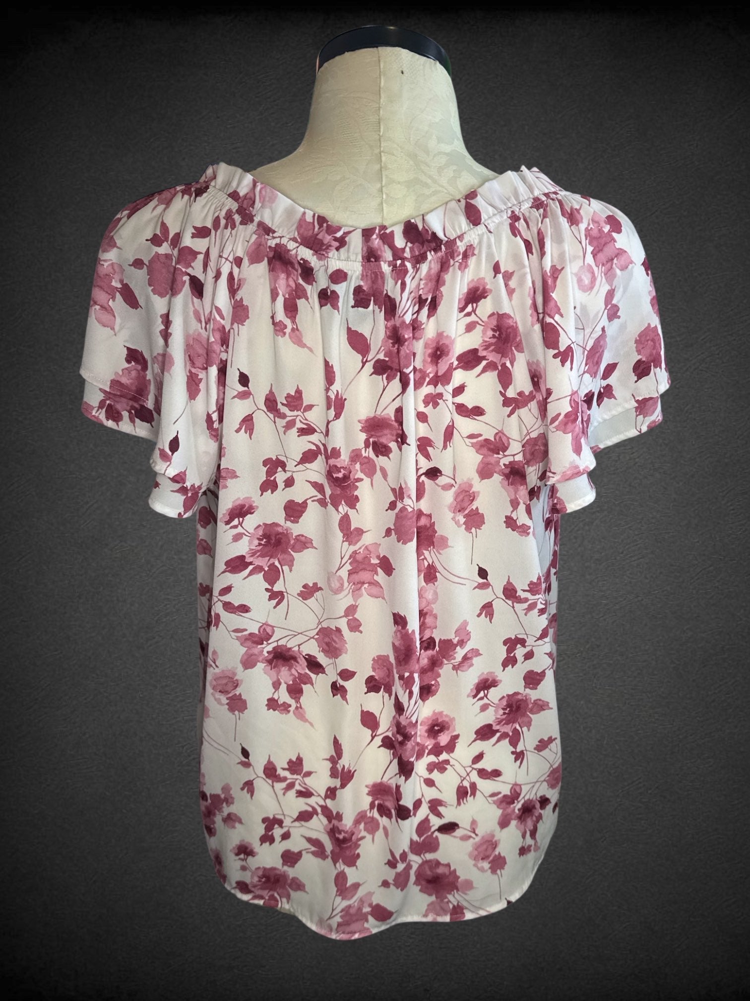 2X COUNTERPARTS white top with magenta floral patter, elastic neckline, drawstring tie, and flowy short sleeves