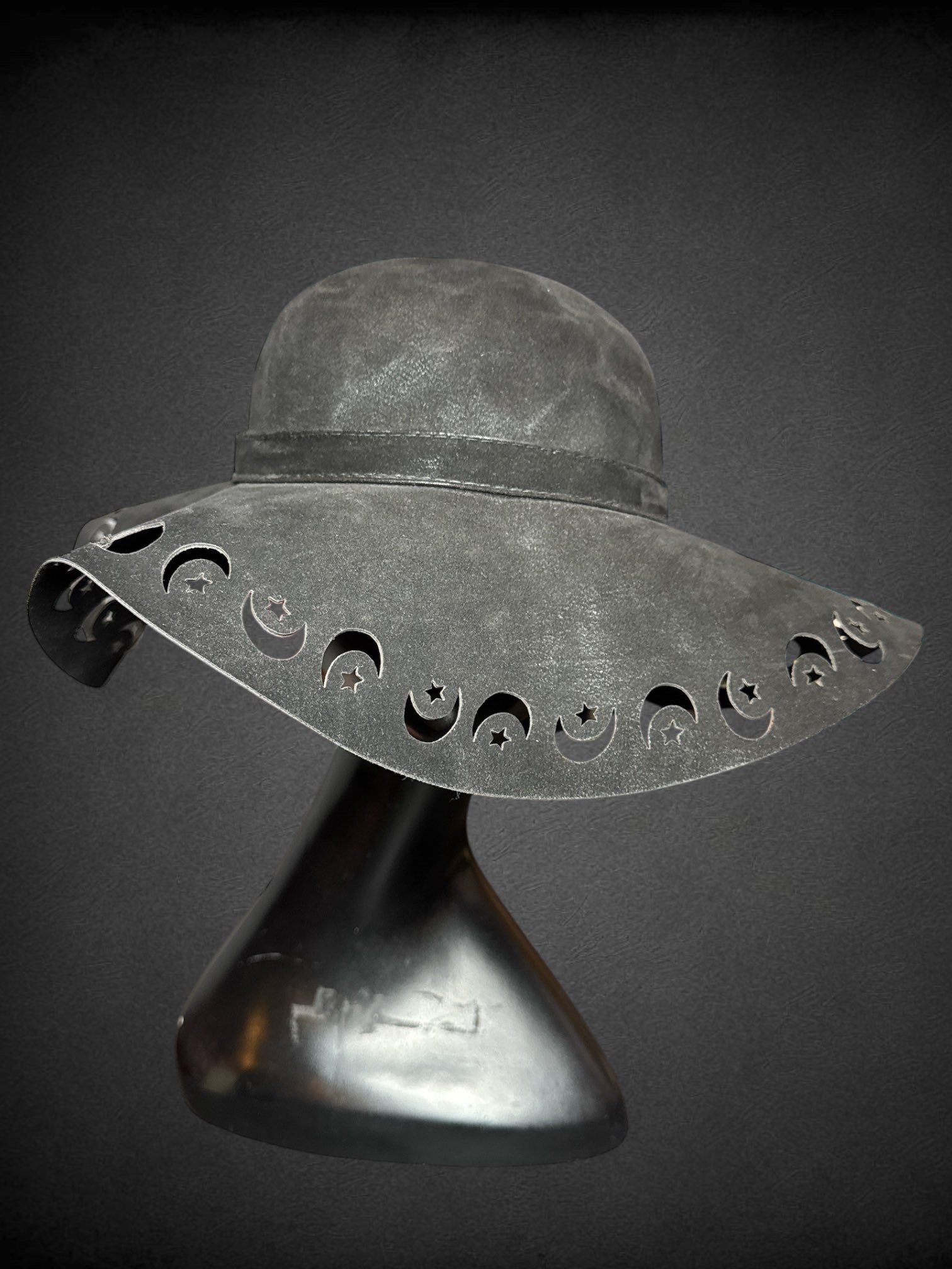 Black pleather suede like sun hat with moon and star cutouts