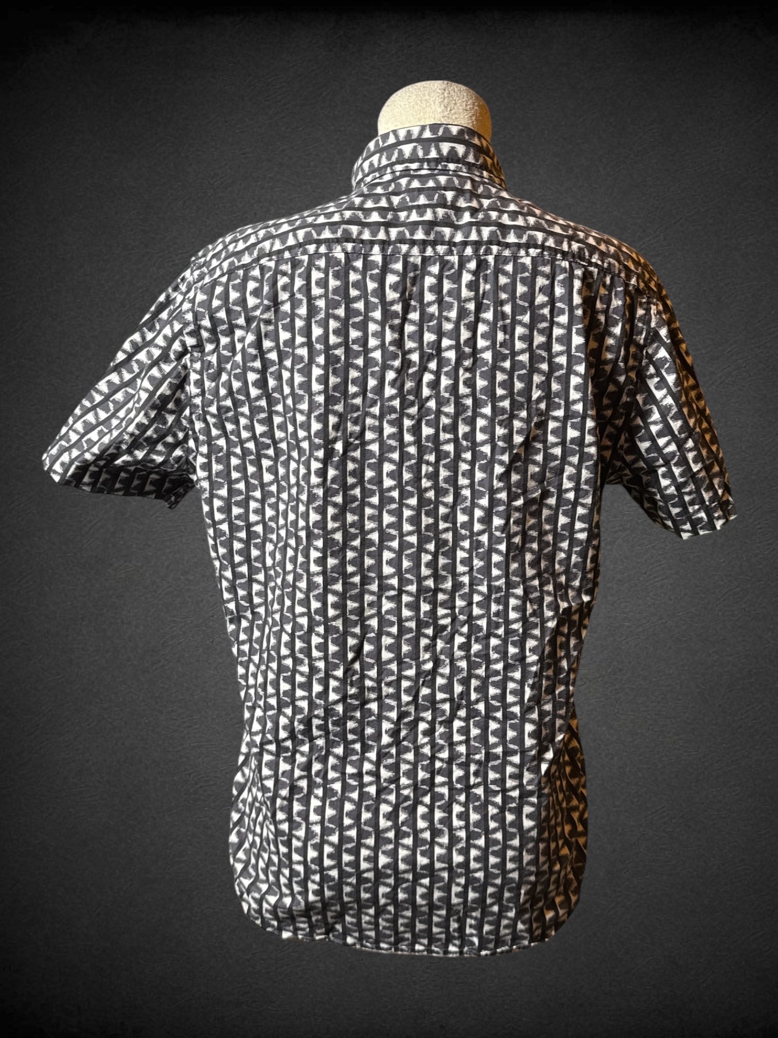 M Express navy blue, white, and black short sleeve button up with zigzag, and striped design