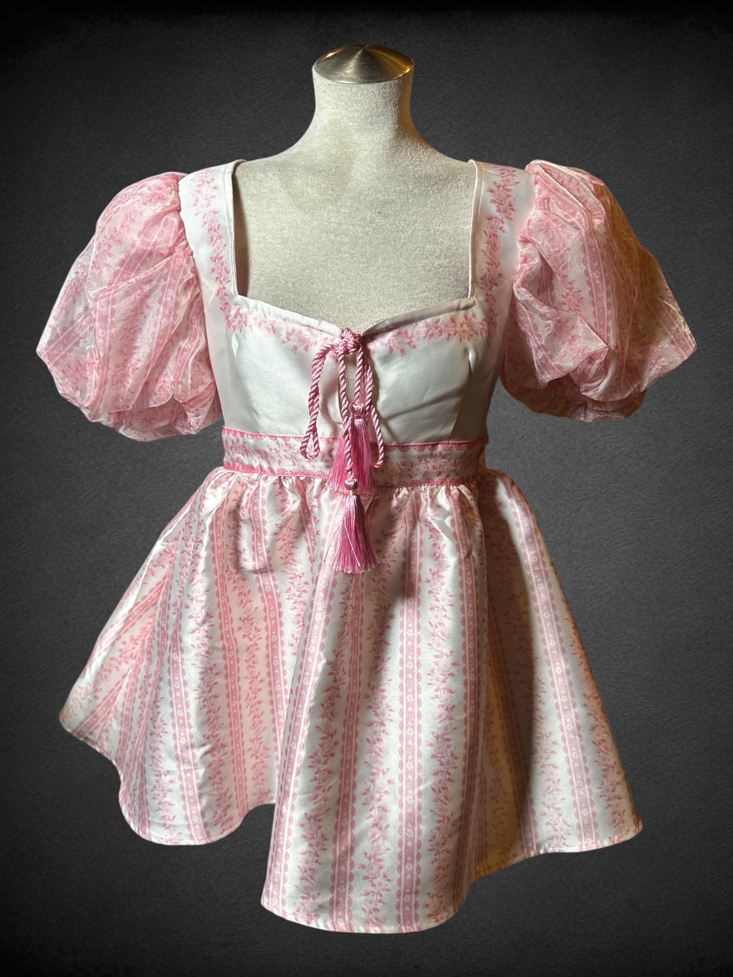 M Sugar Thrills white and pink balloon sleeve dress with braided rope tie on neckline, mesh ribbon tie and zipper on back, and puffed skirt