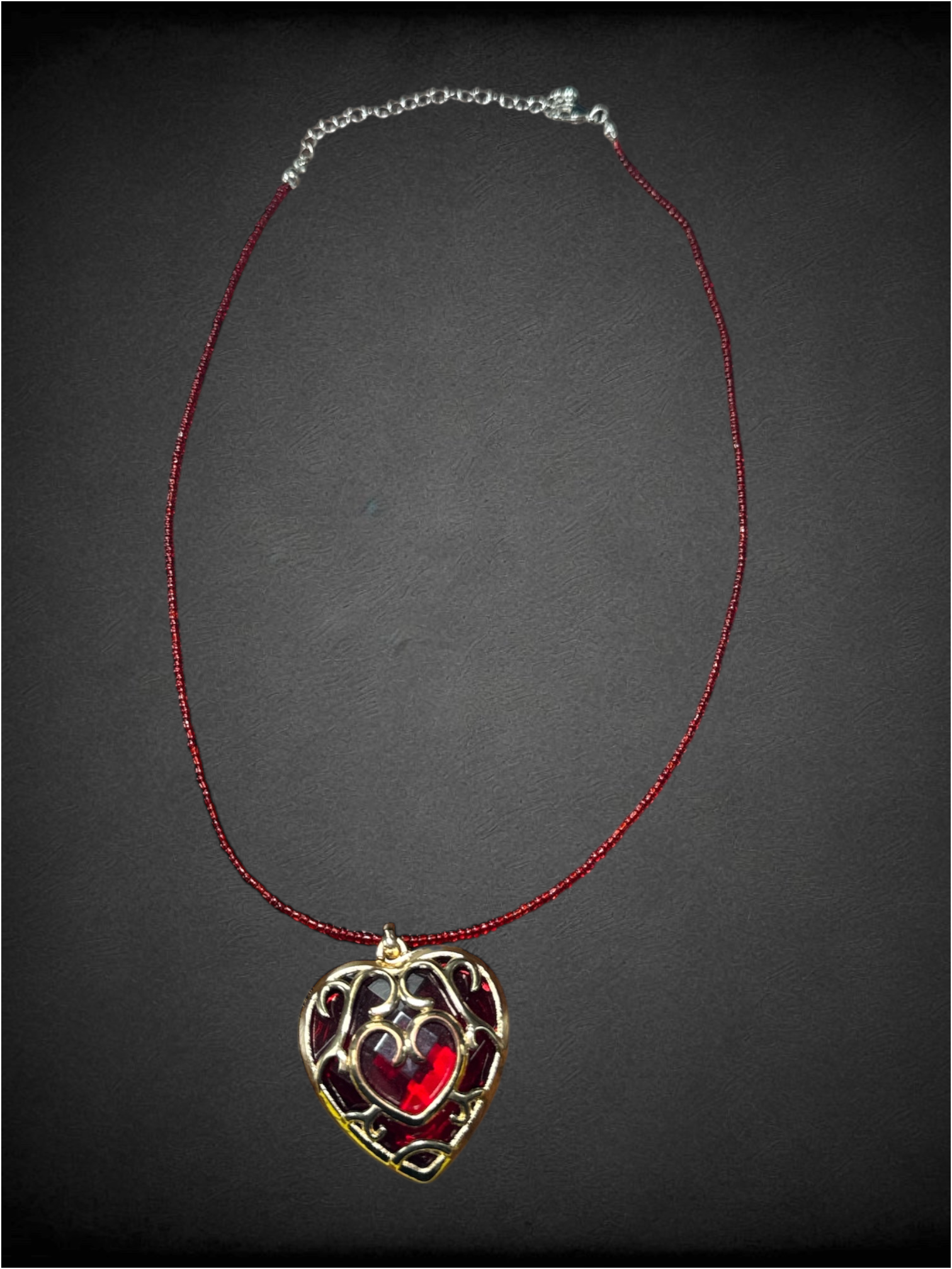 Red beaded chain with "Heart Container" pendant from The Legend of Zelda