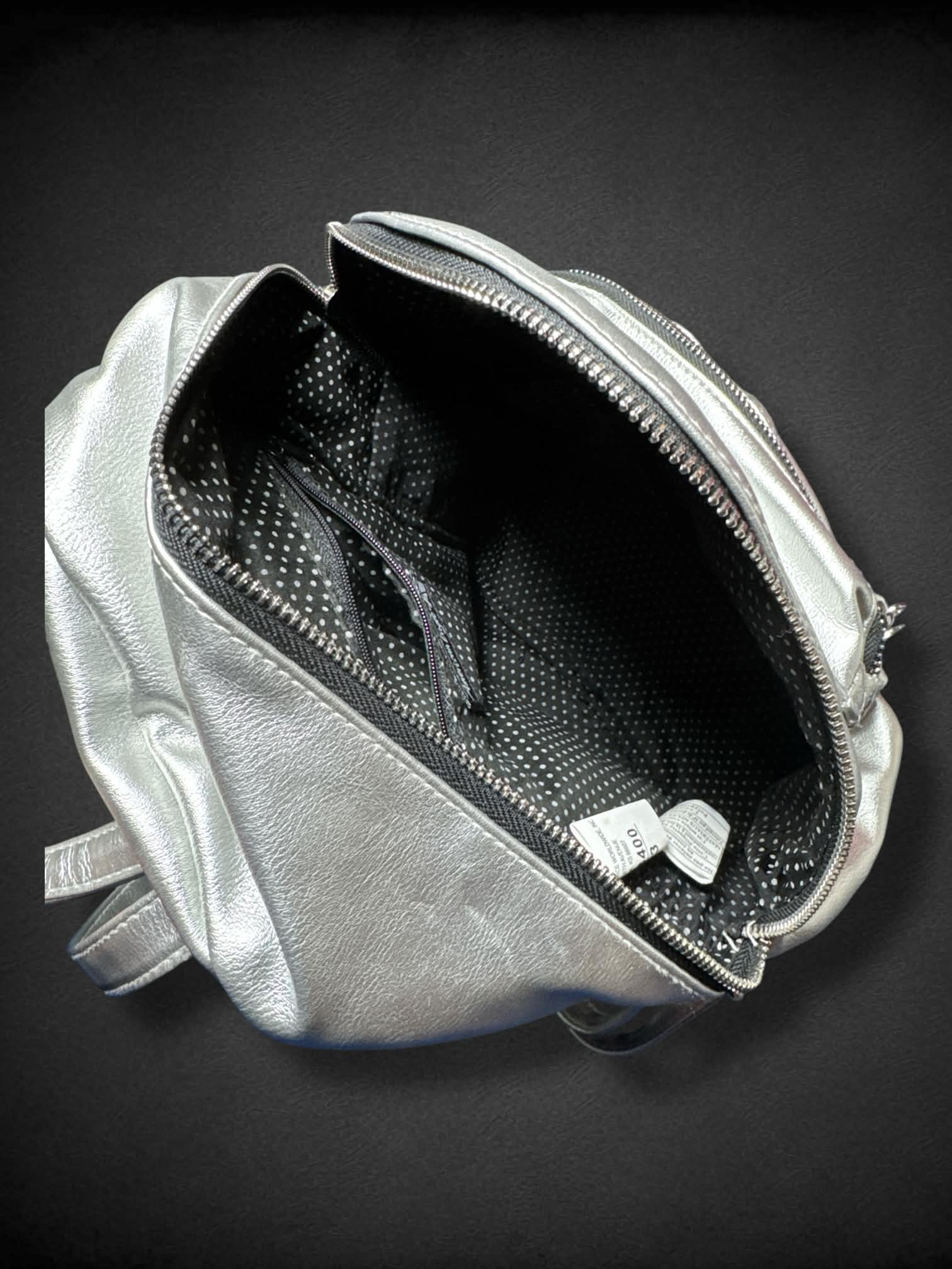 American Eagle Silver Mini Backpack with black and white polka dot interior