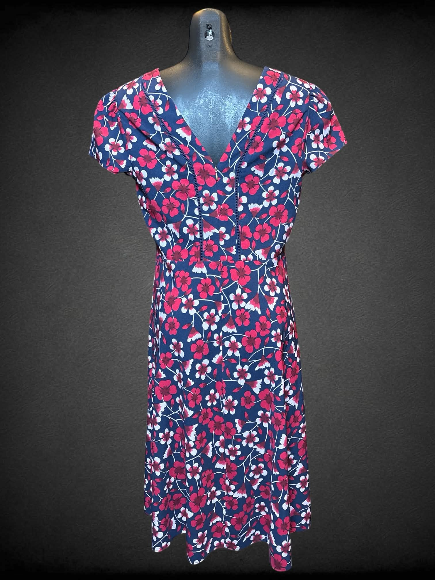 S Draper James navy blue short sleeve dress with pink floral design, zipper on back, and faux wrap design