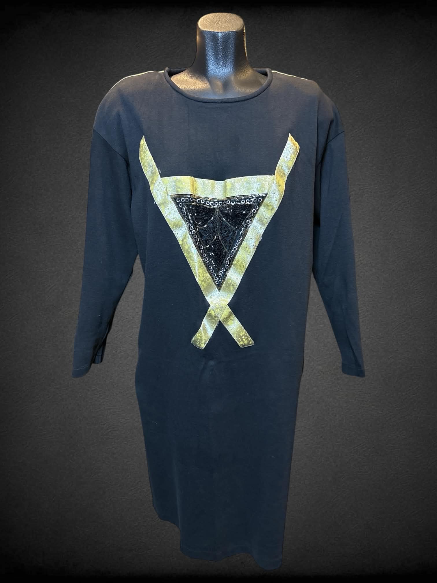 L Sarafino vintage black long sleeve dress with shoulder pads, gold and beaded triangle design on front, and gold stripes going down sleeves