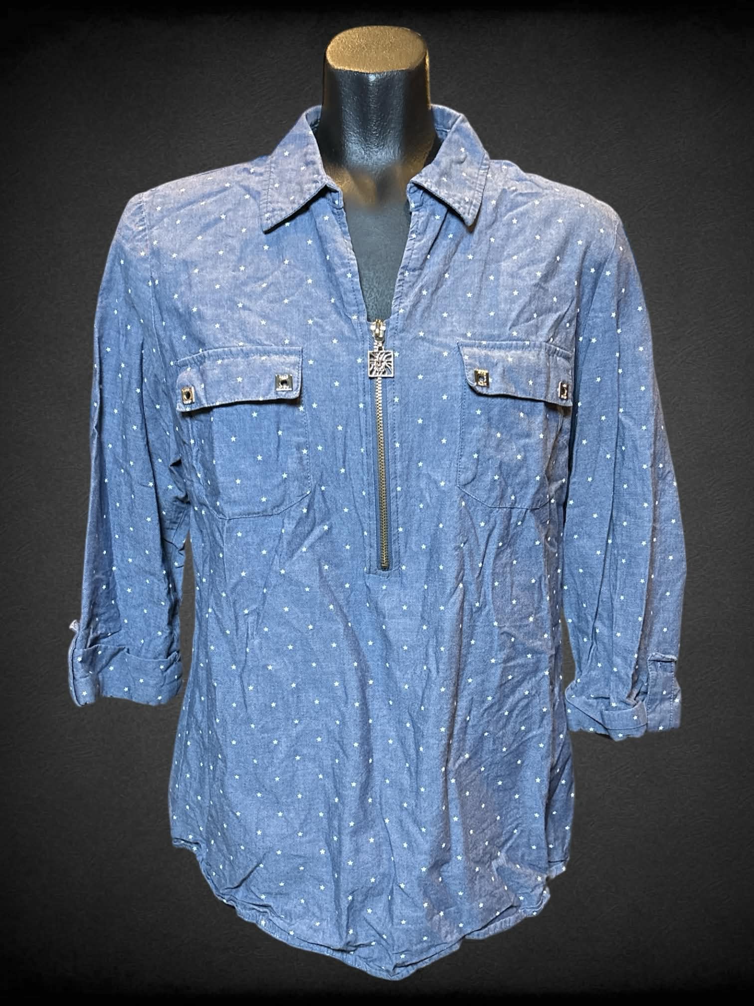 L Anne Klein blue half sleeve top with zipper collar, two chest pockets, and star polka dots