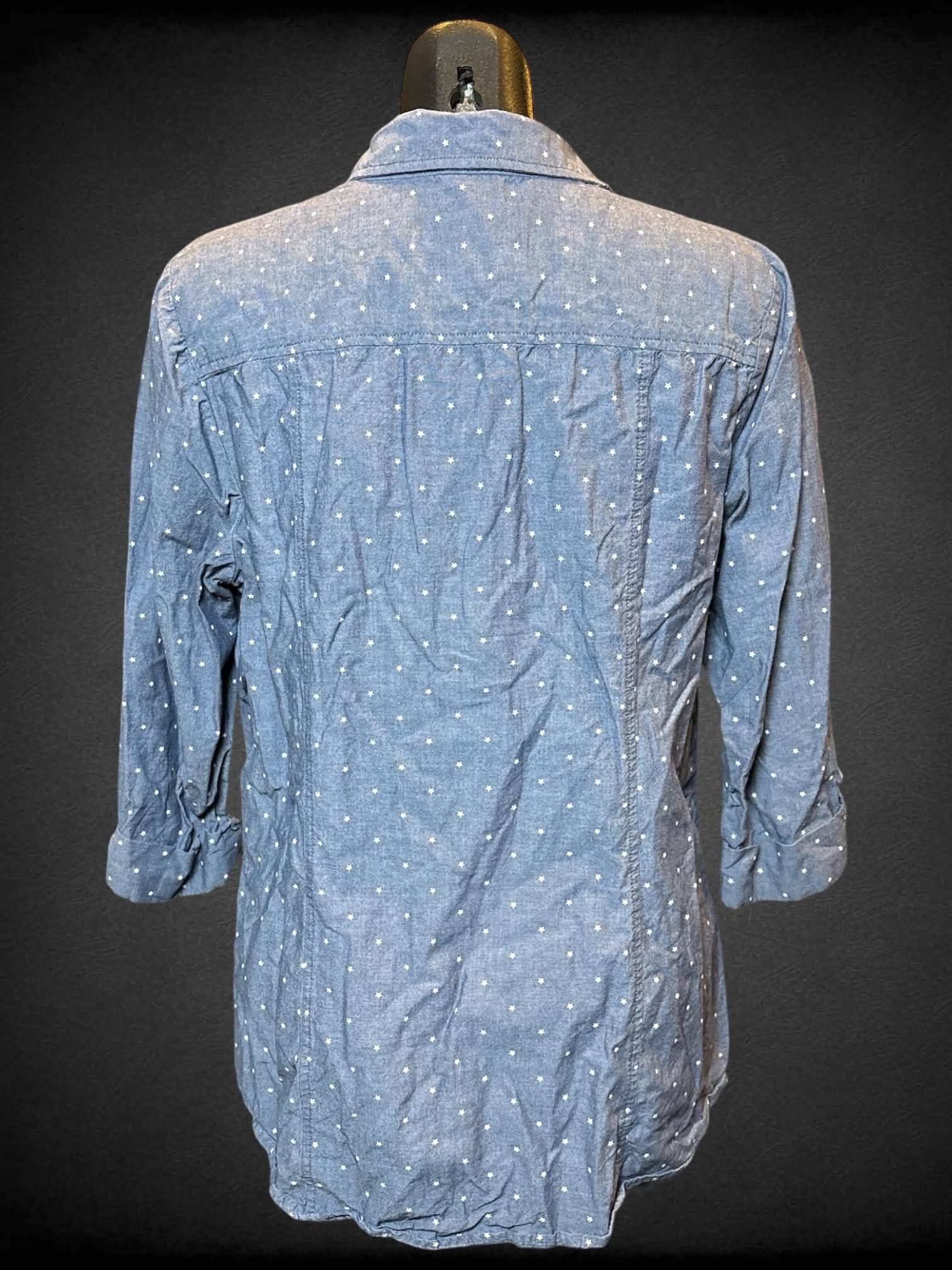 L Anne Klein blue half sleeve top with zipper collar, two chest pockets, and star polka dots