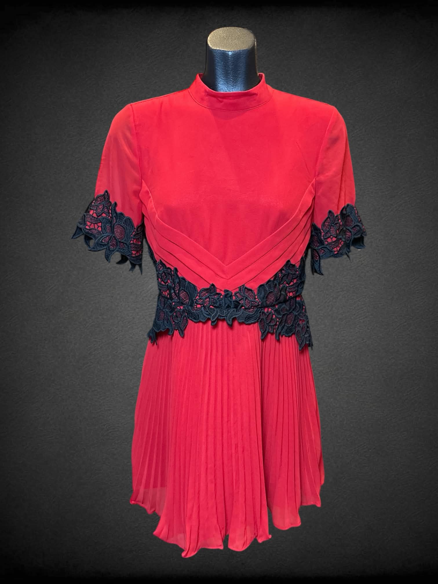 S ASOS red short sleeve dress with black lace details on waist and sleeves, zipper on back, and pleated bottom
