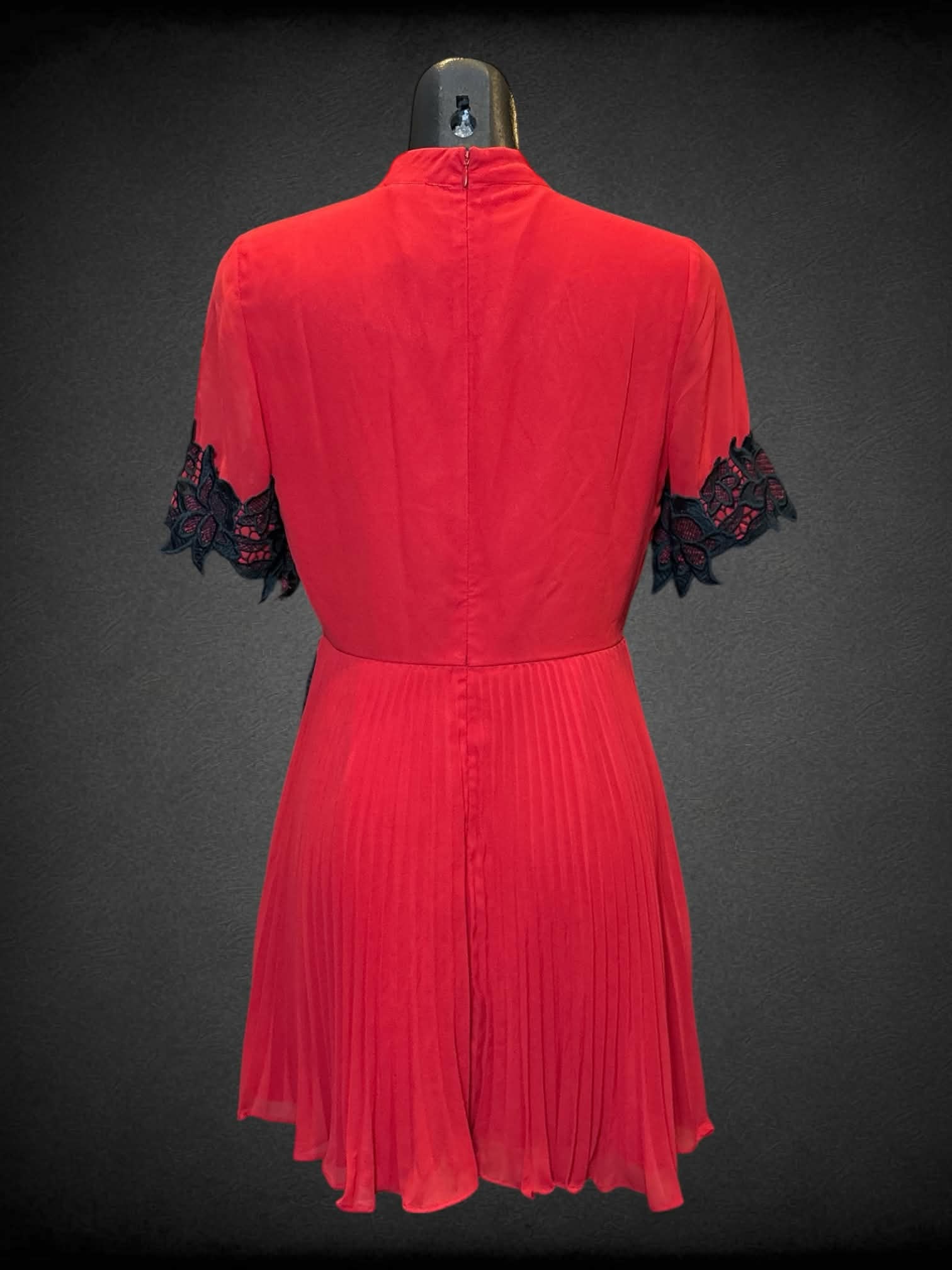 S ASOS red short sleeve dress with black lace details on waist and sleeves, zipper on back, and pleated bottom