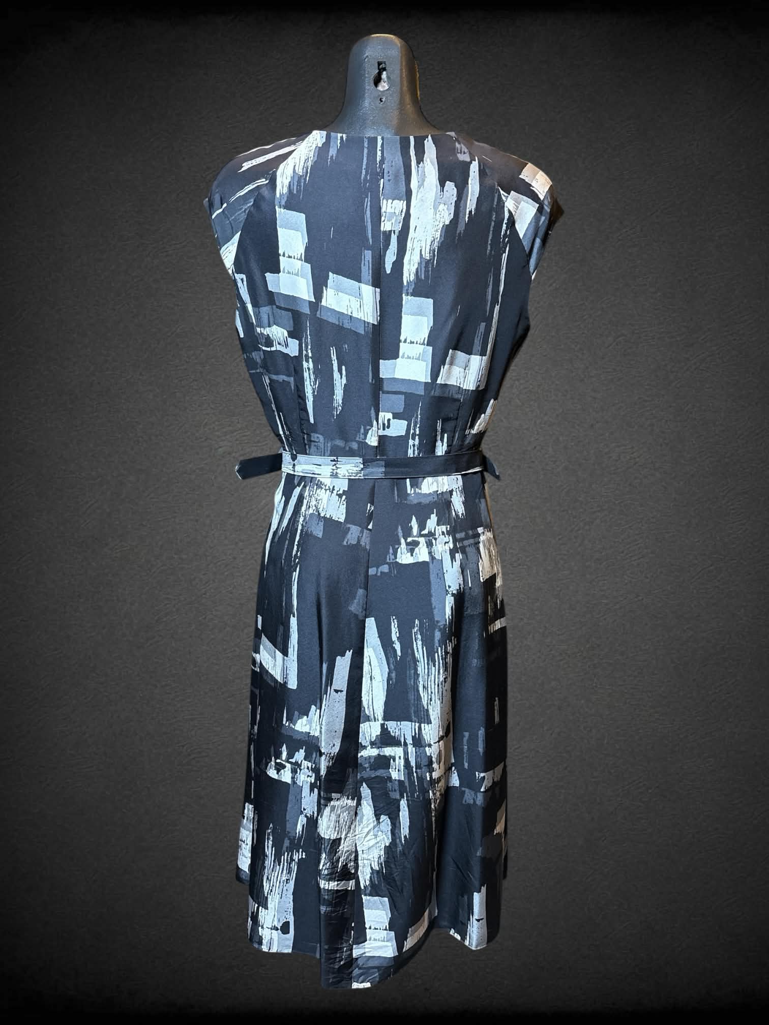 M L.K. Bennett black and white abstract designed dress with matching double buckle belt, zipper on side, and pleated details
