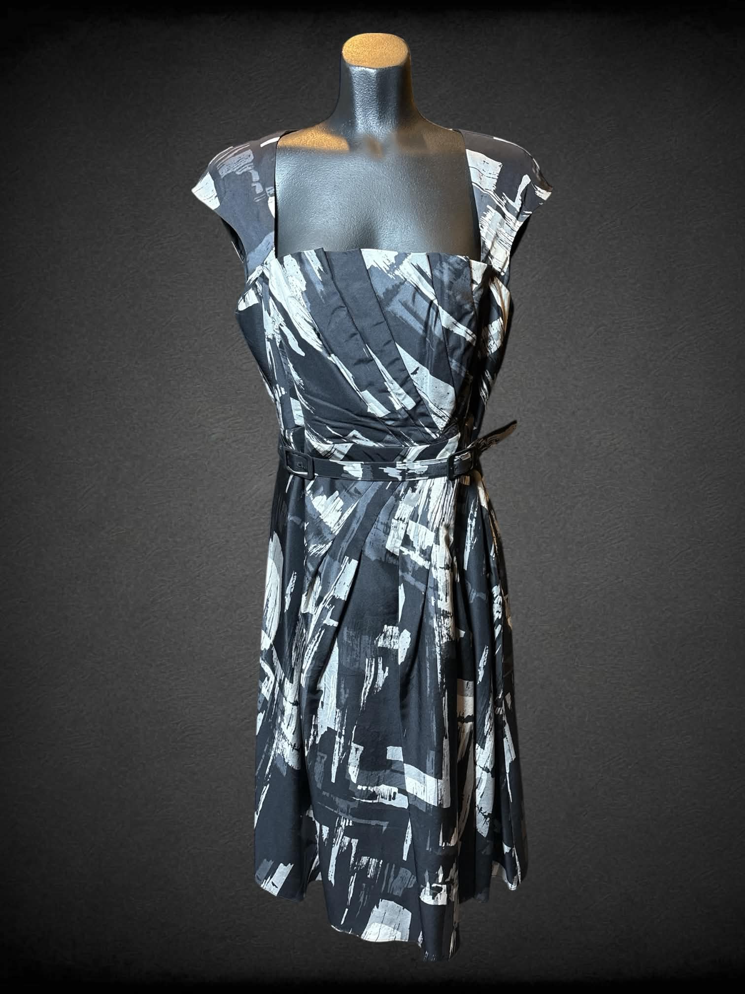 M L.K. Bennett black and white abstract designed dress with matching double buckle belt, zipper on side, and pleated details
