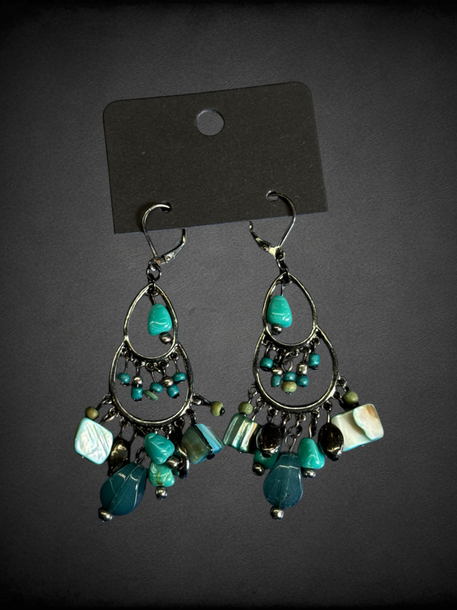 Chandelier dangle earrings featuring turquoise-colored beads and mixed metal components