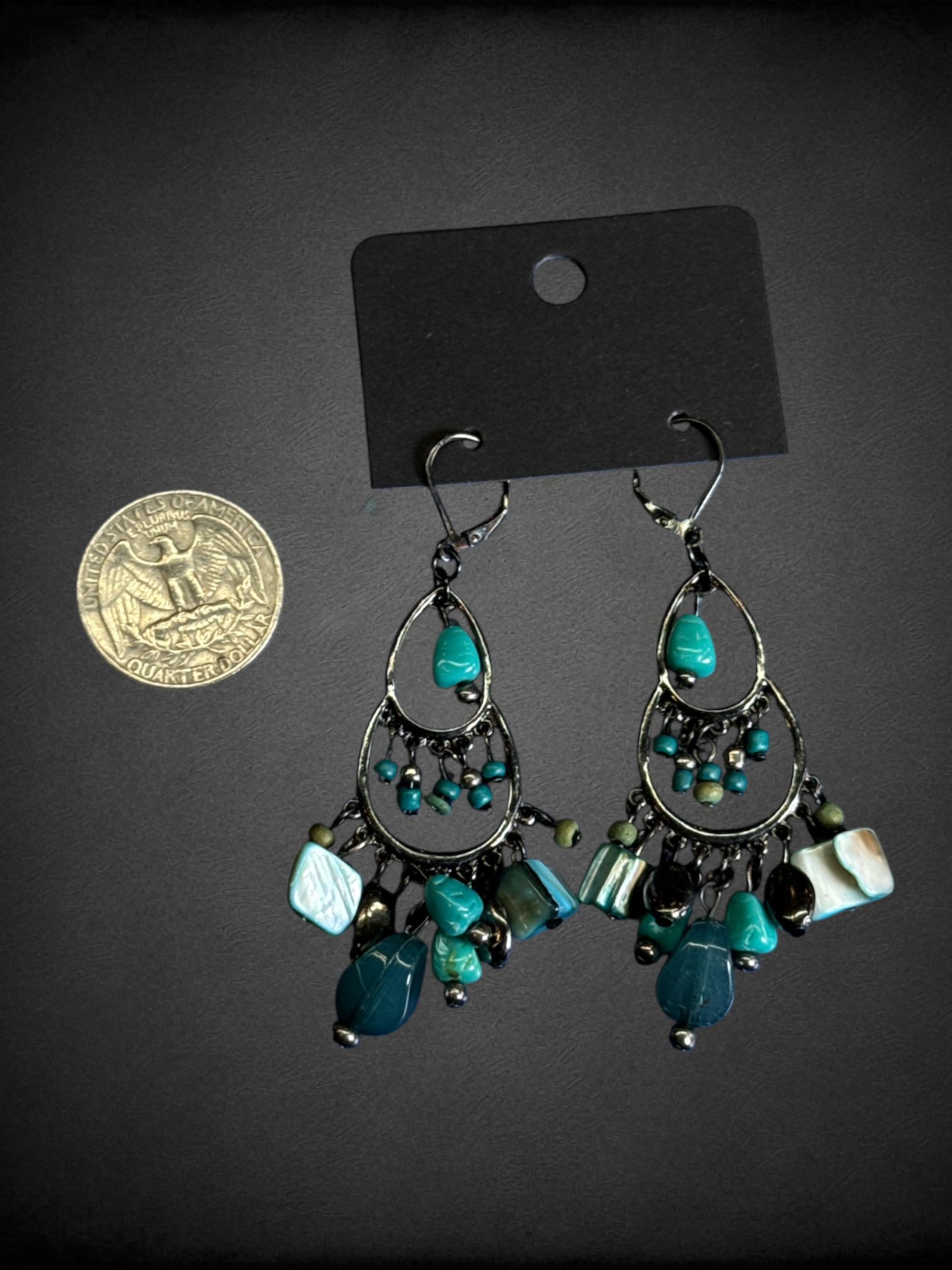 Chandelier dangle earrings featuring turquoise-colored beads and mixed metal components