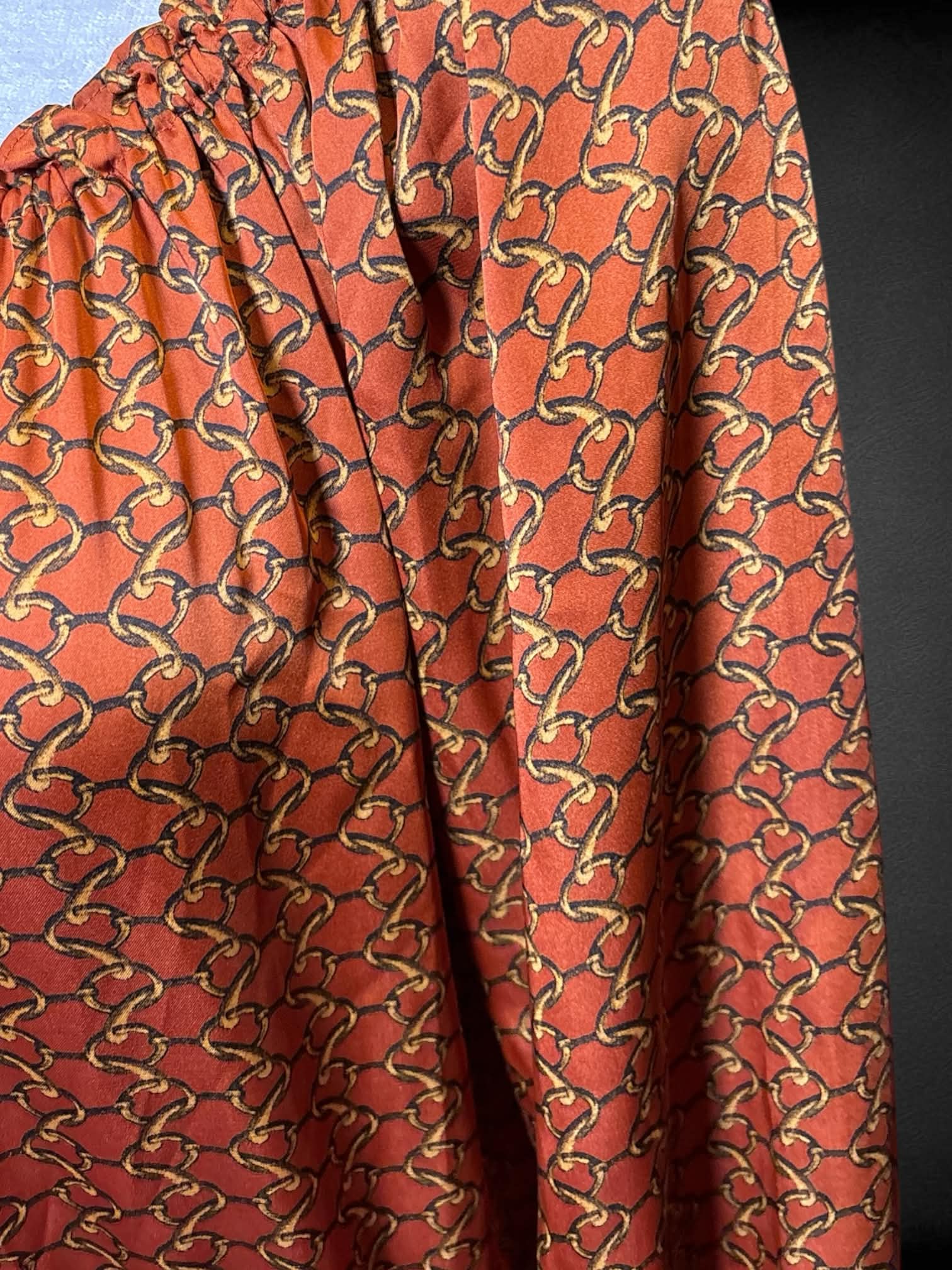 L Michael Kors orange long sleeve top with gold chain design, & elastic hems