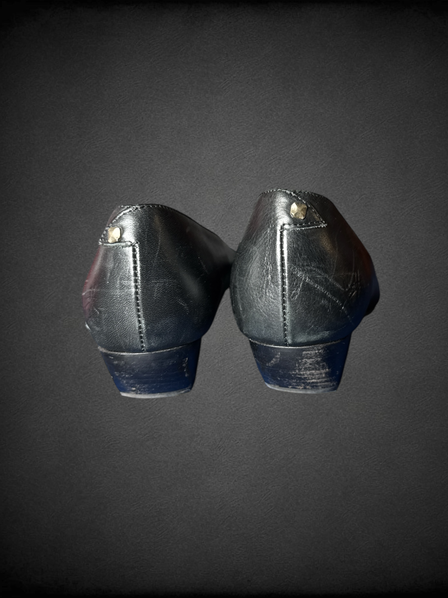 Size 7.5 John Fluevog Makena slip-on shoes featuring a pointed toe, a large metal ring, and stud detailing and dust bag included