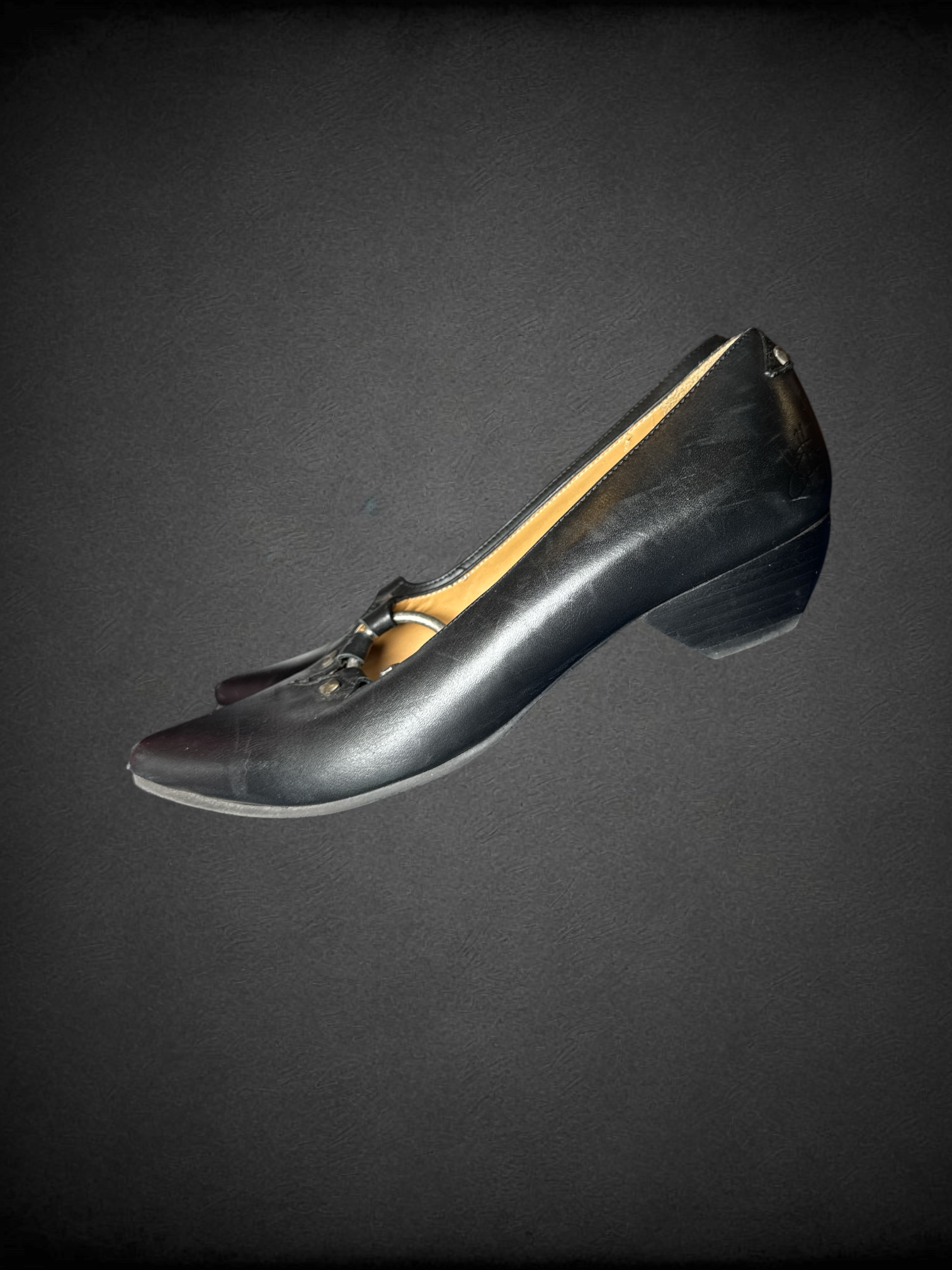 Size 7.5 John Fluevog Makena slip-on shoes featuring a pointed toe, a large metal ring, and stud detailing and dust bag included