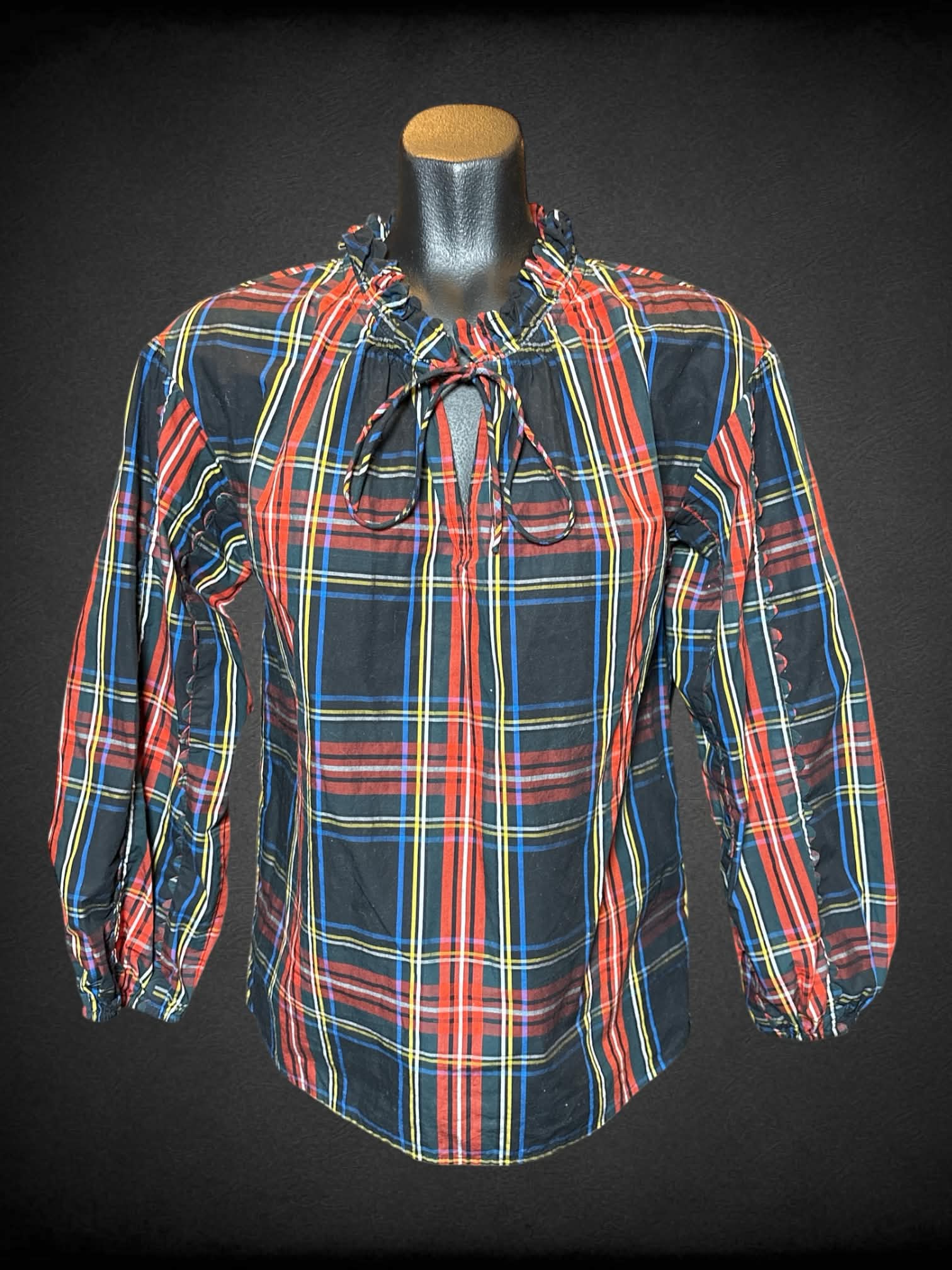 S J Crew black long sleeve plaid top with ruffled neck, tie on neck, and scalloped design on sleeves