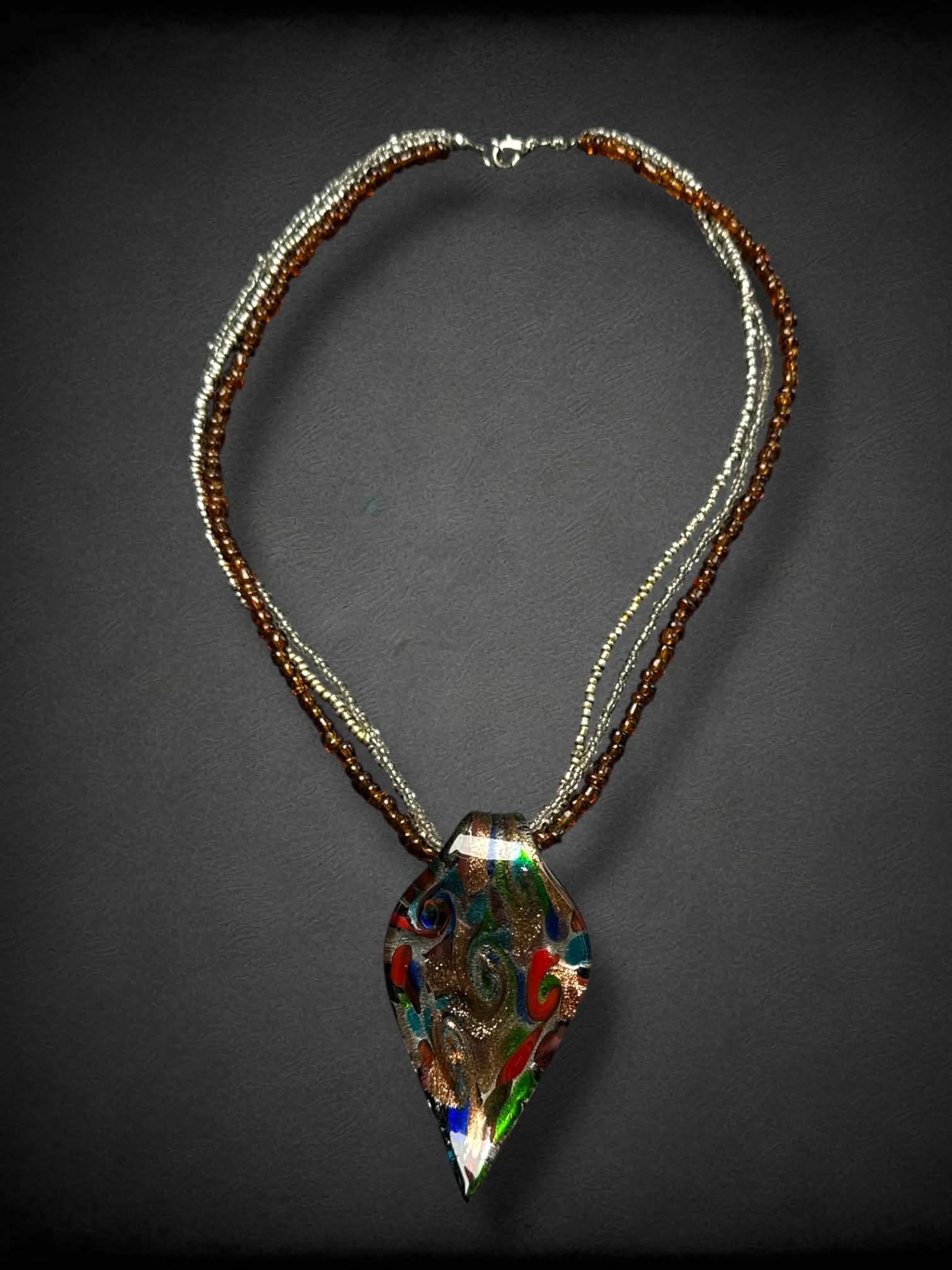 Multicolor spiral glass leaf necklace with multiple beaded strands