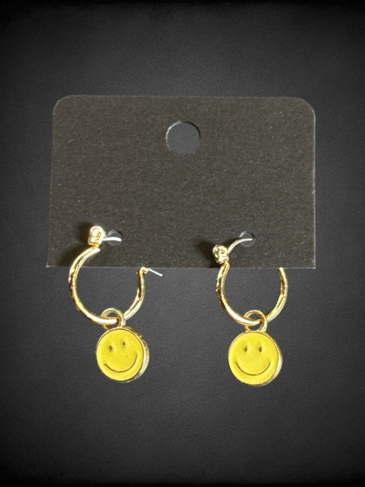 Gold tone earrings with yellow smiley face