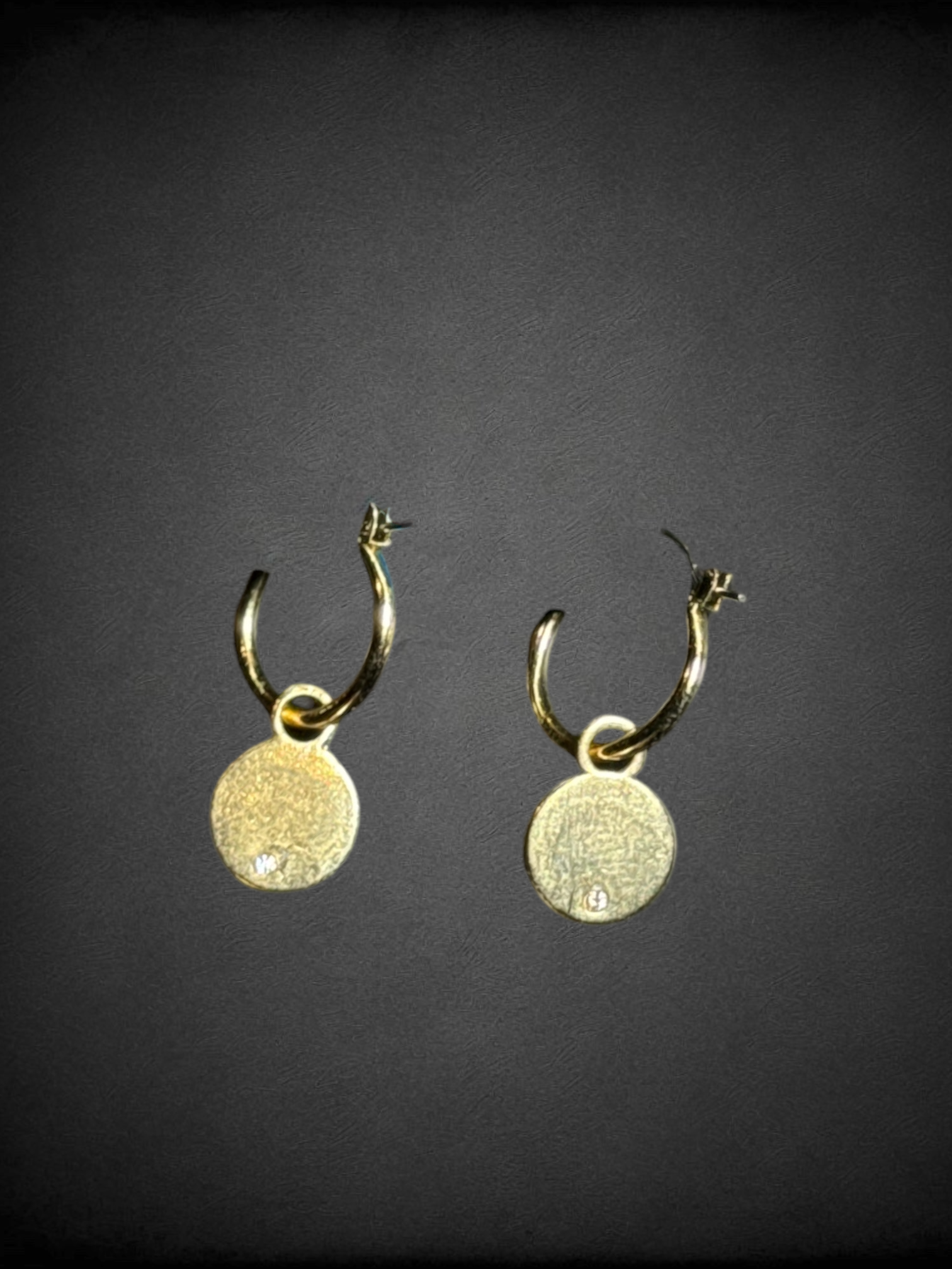 Gold tone earrings with yellow smiley face