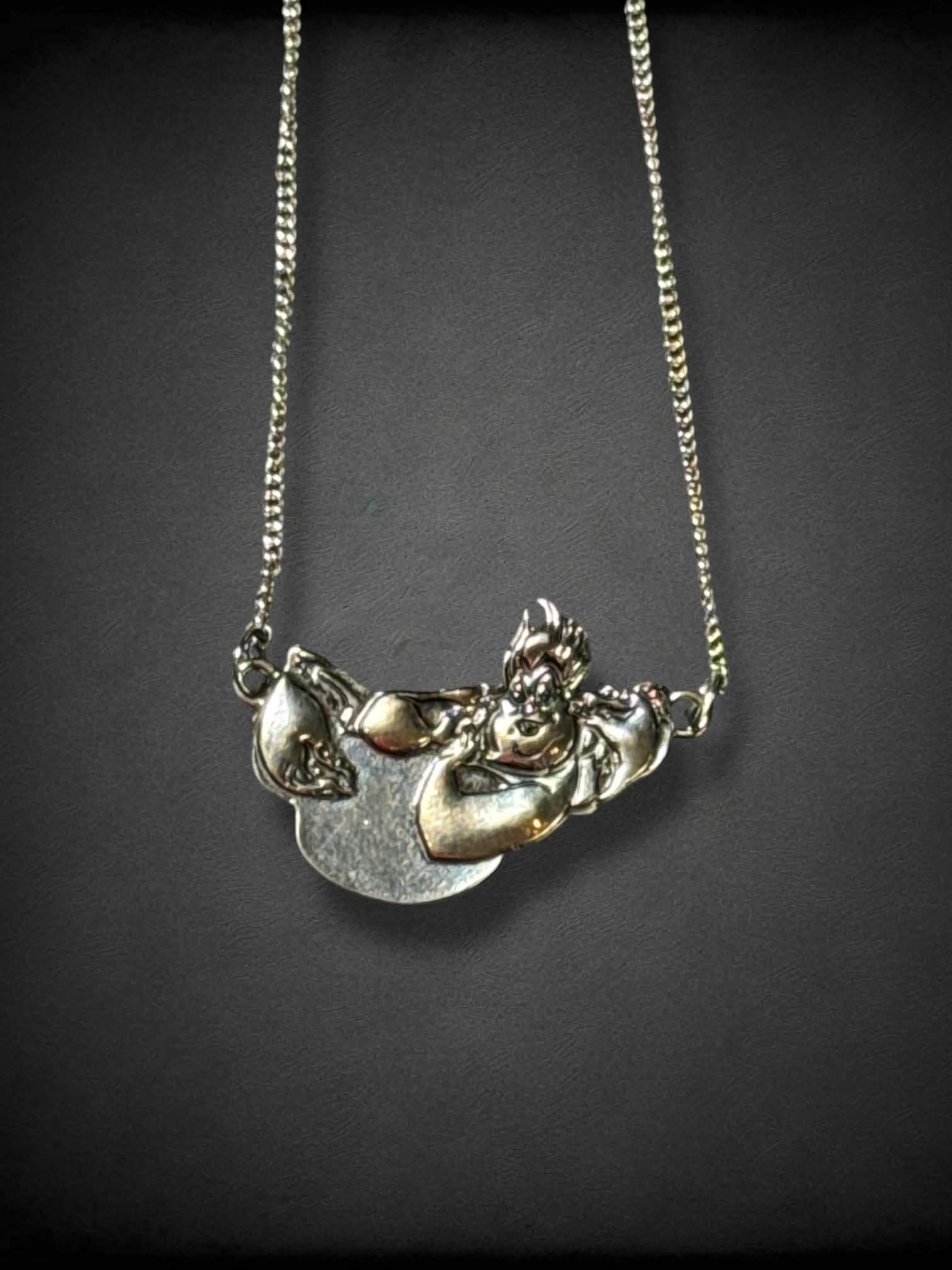 Silver tone necklace with Disney’s Ursula, Flotsam, and Jetsam