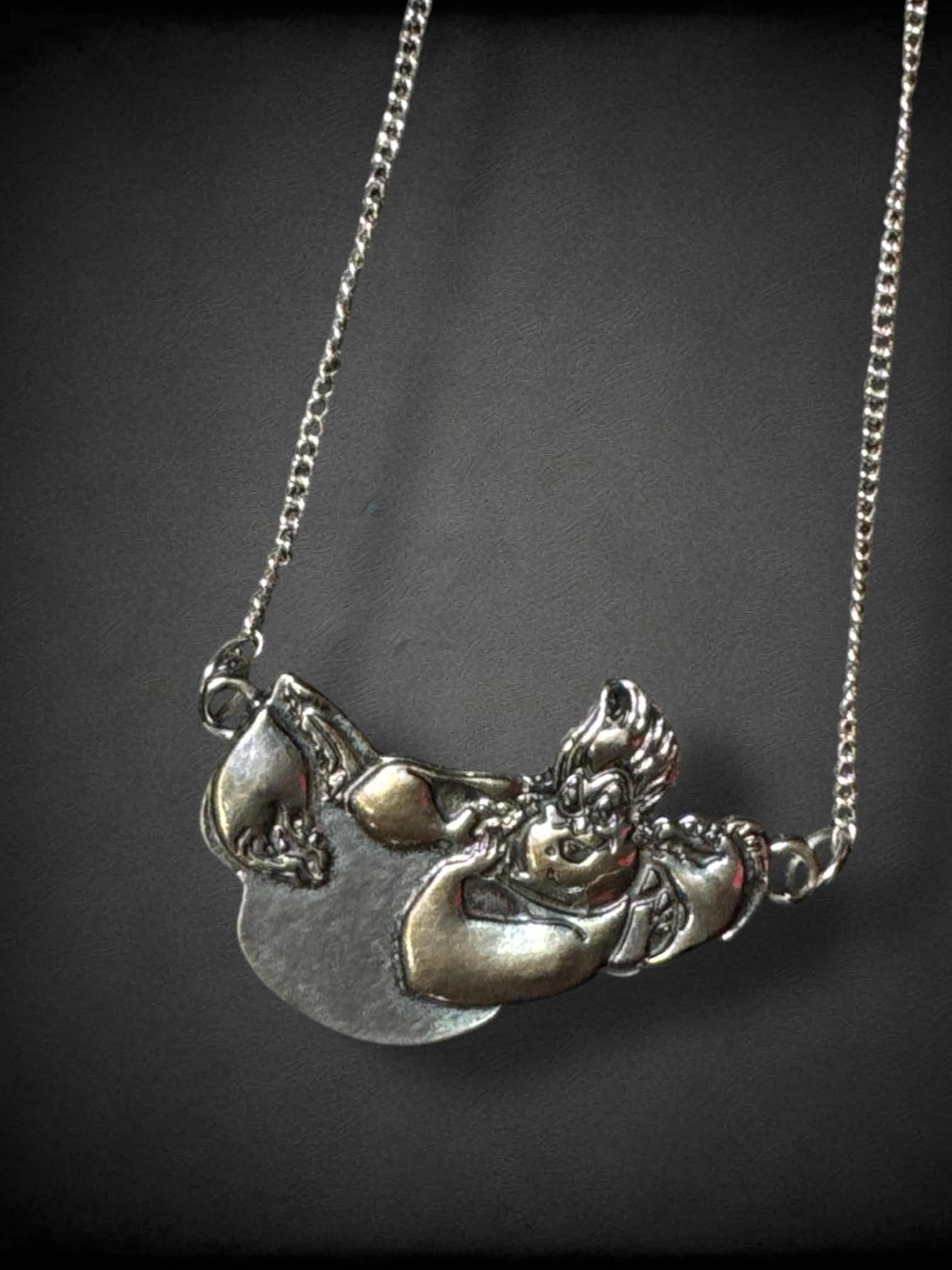 Silver tone necklace with Disney’s Ursula, Flotsam, and Jetsam