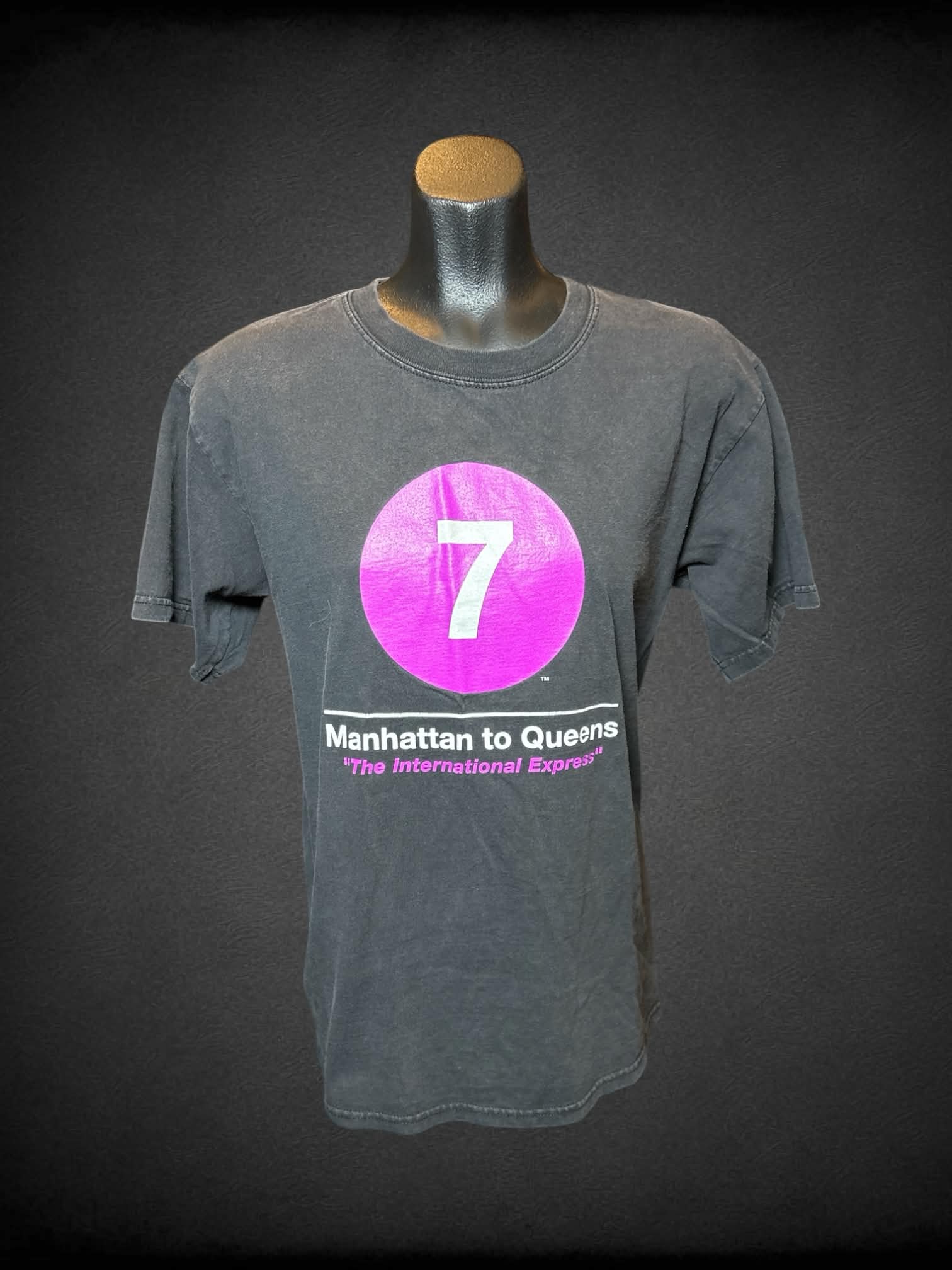 M NYC Subway Line black t shirt with “7, Manhattan to Queens” graphic