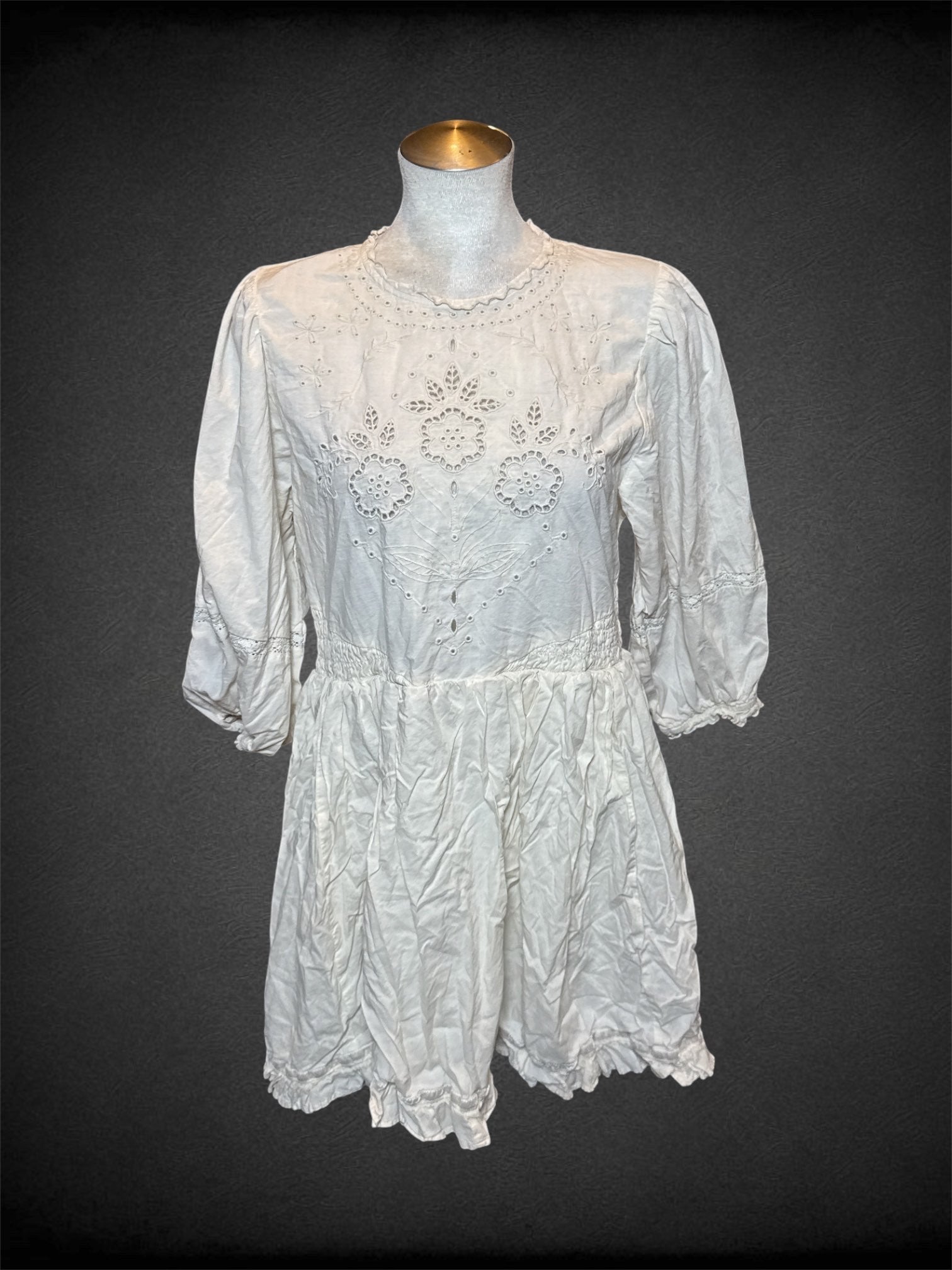 L American Eagle white half sleeve dress with floral designed eyelets, and keyhole/button on back