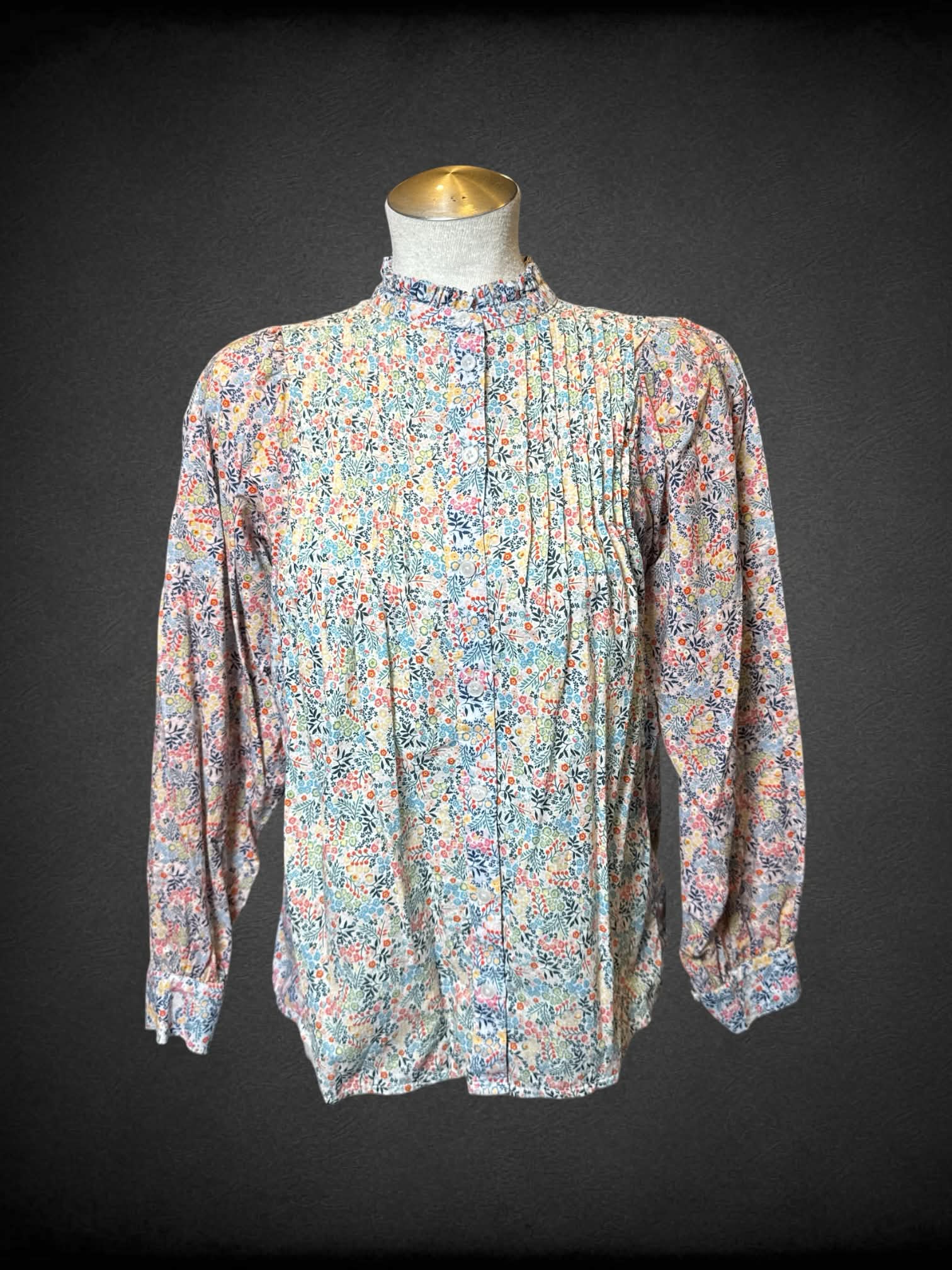 L Boden white long sleeve button up with multicolor floral design, pleating on chest, and ruffle collar