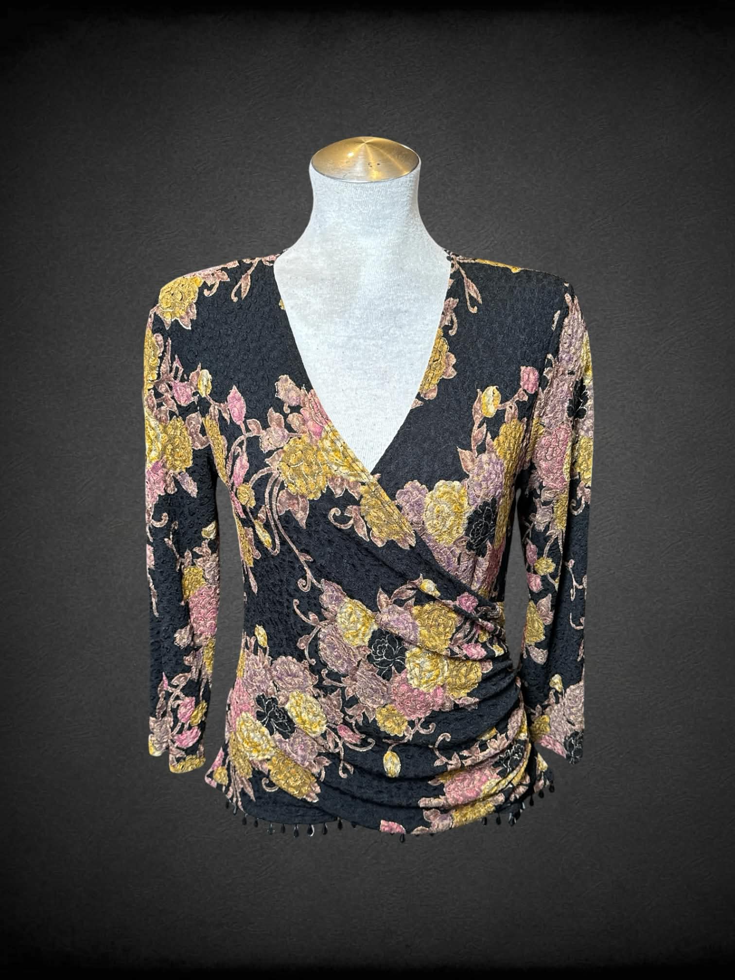 L Dressbarn black long sleeve faux wrap top with pink and gold florals, and beading on bottom