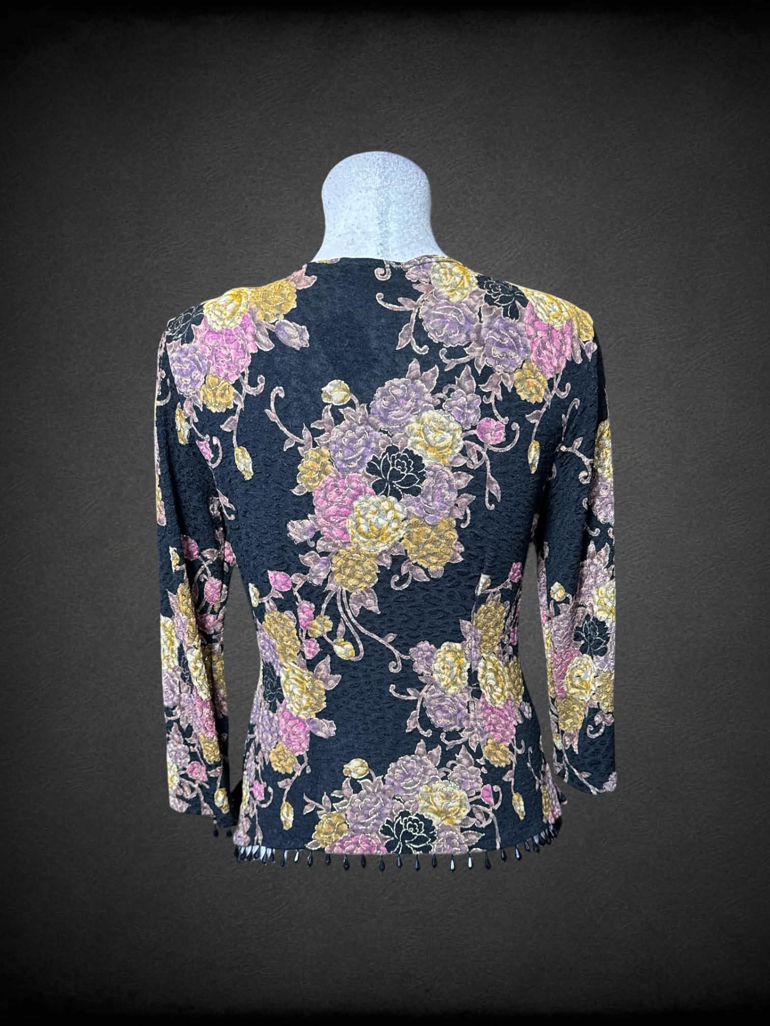L Dressbarn black long sleeve faux wrap top with pink and gold florals, and beading on bottom