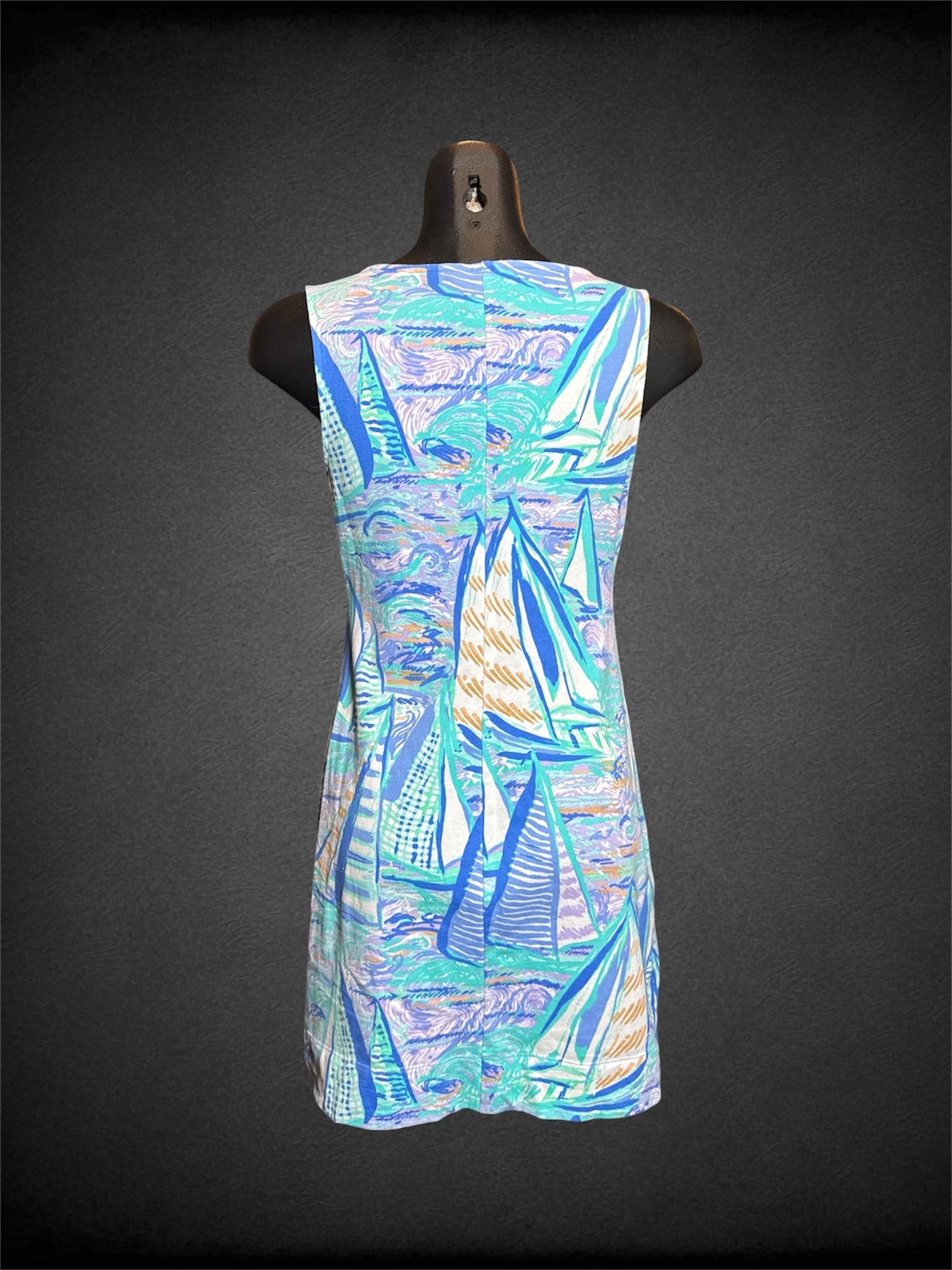 S Lily Pulitzer cool tone sleeveless dress with sailboats on water design, white wavy Pom Pom design on front