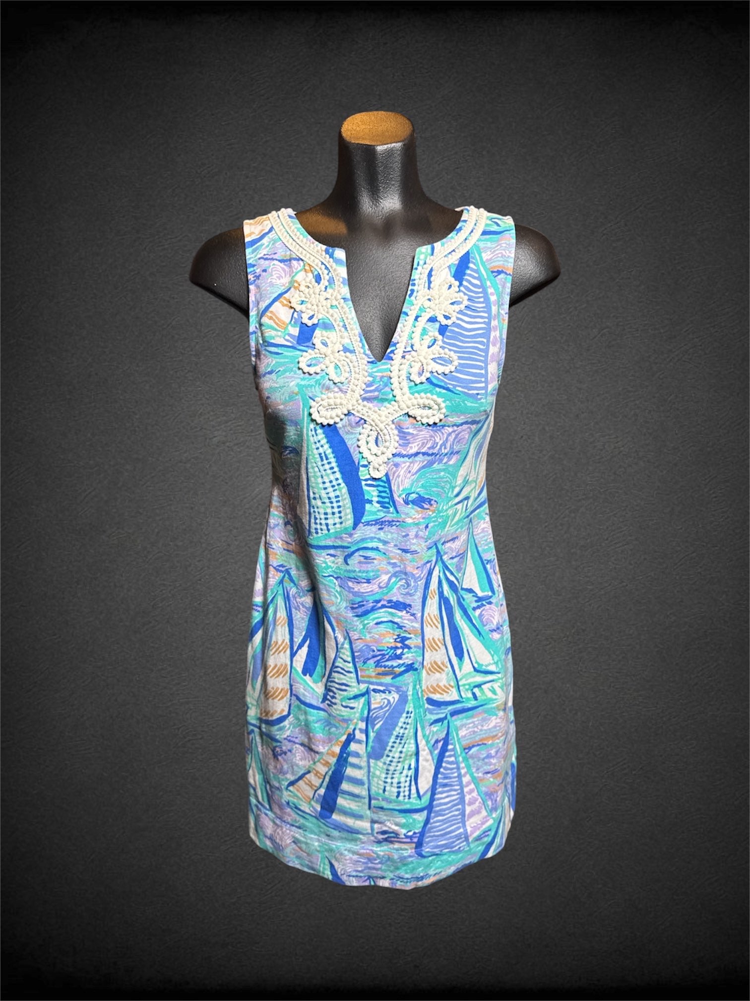 S Lily Pulitzer cool tone sleeveless dress with sailboats on water design, white wavy Pom Pom design on front