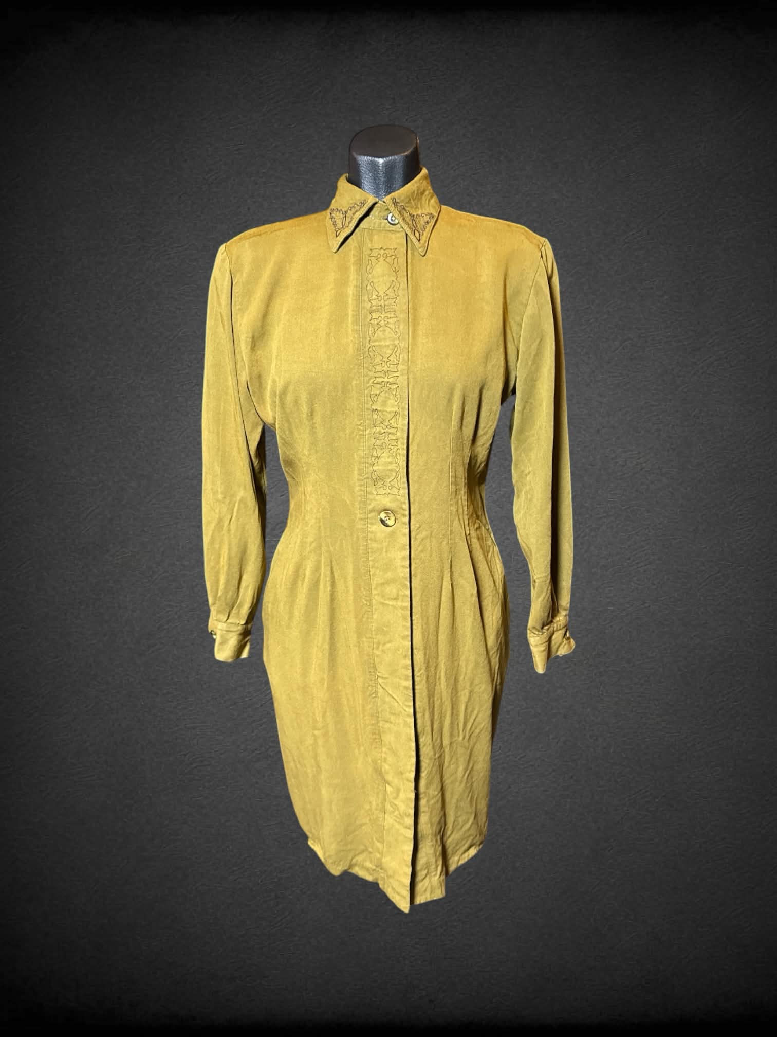 M WildRose green long sleeve button up dress with black ornate embroidery on front, and pockets