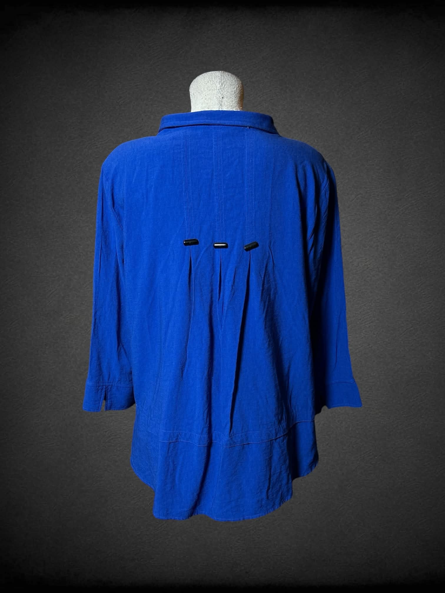 L blue layered blouse with three-quarter sleeves, buttons on top and decorative buttons on back