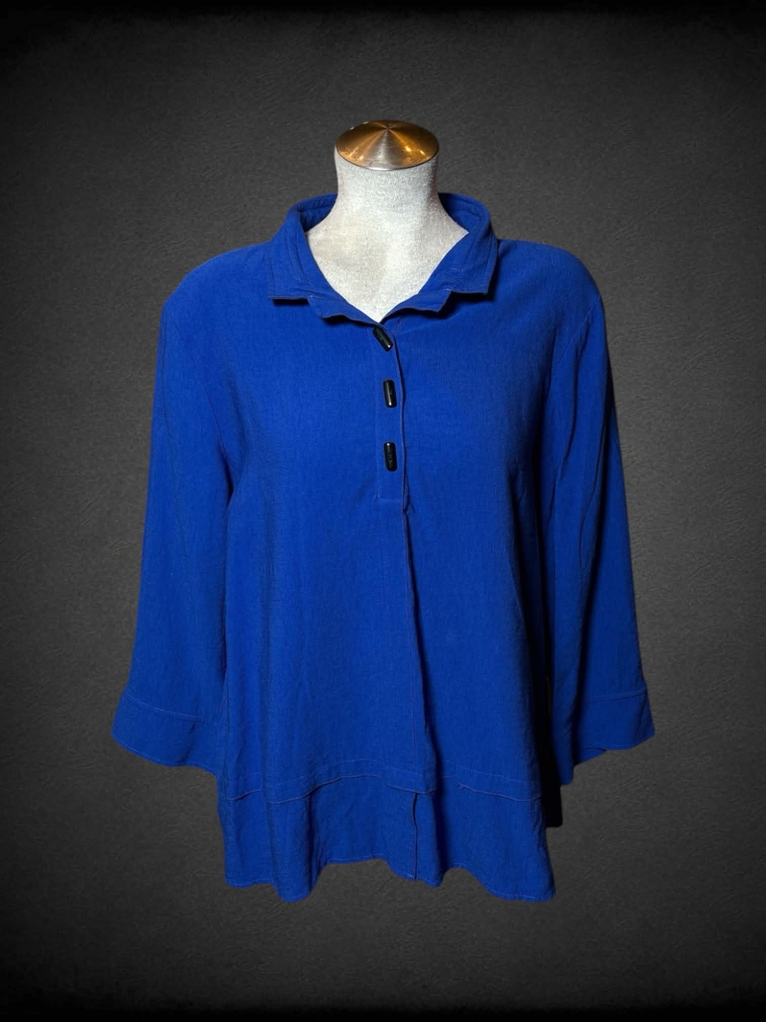 L blue layered blouse with three-quarter sleeves, buttons on top and decorative buttons on back