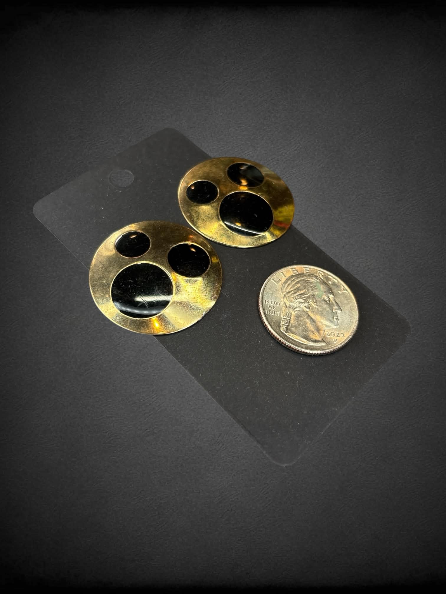 Circular bronze earrings with black circular design