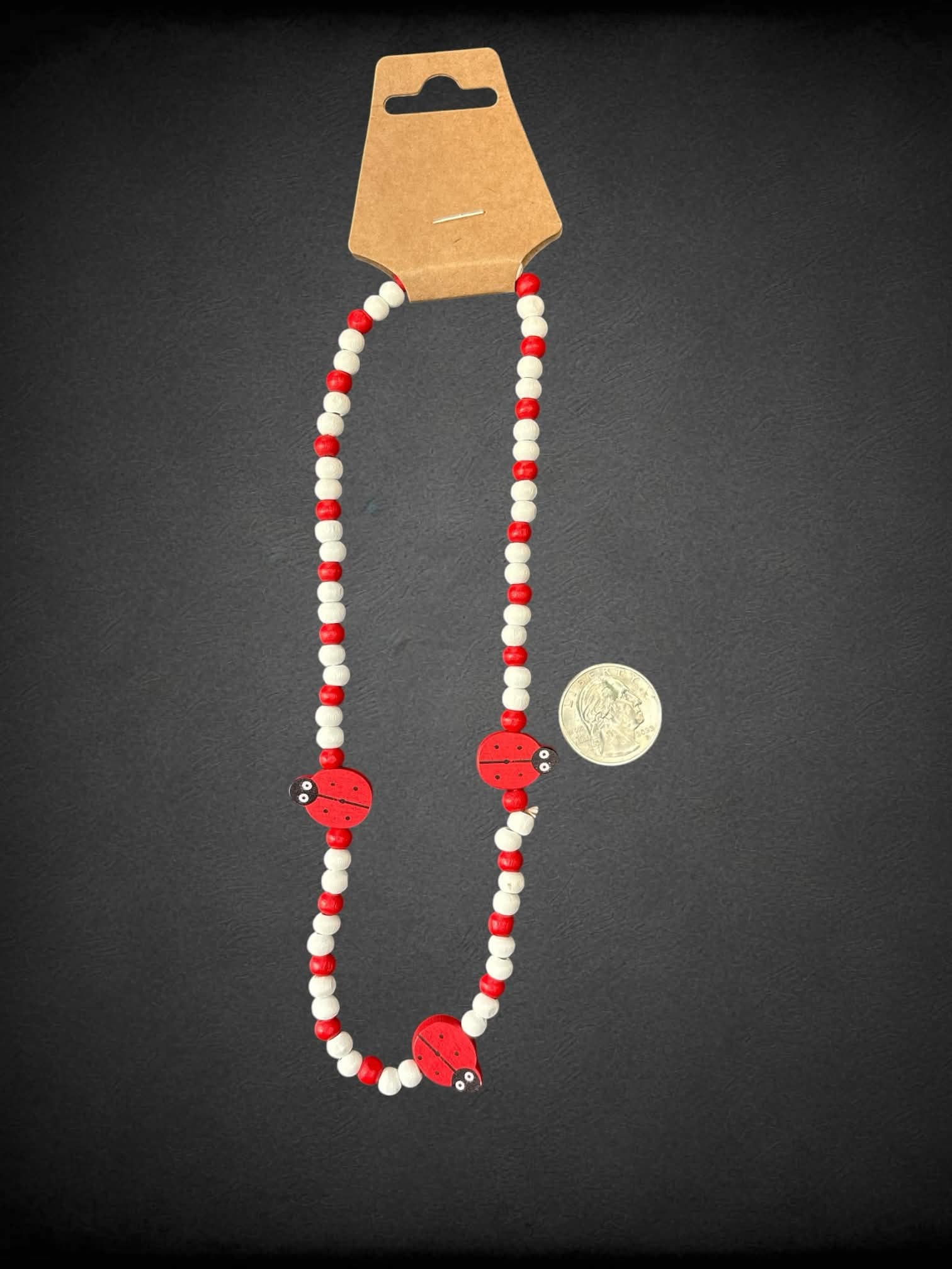Red & white wooden bead necklace with ladybugs