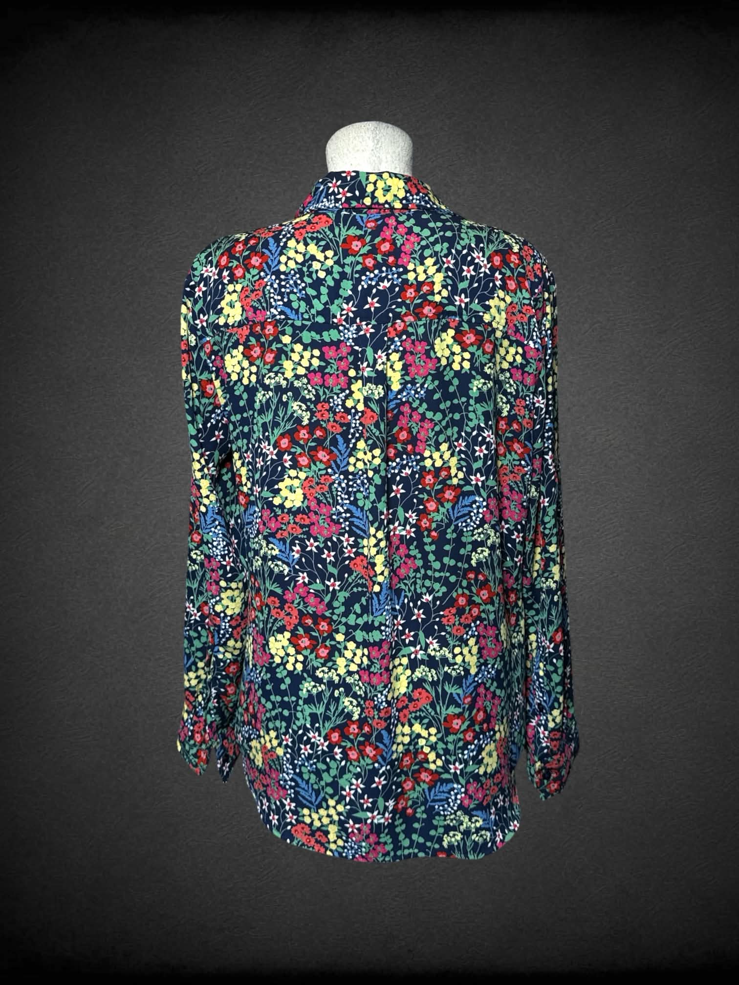 L New York & Company black button-up blouse with colorful floral pattern, and pockets on front