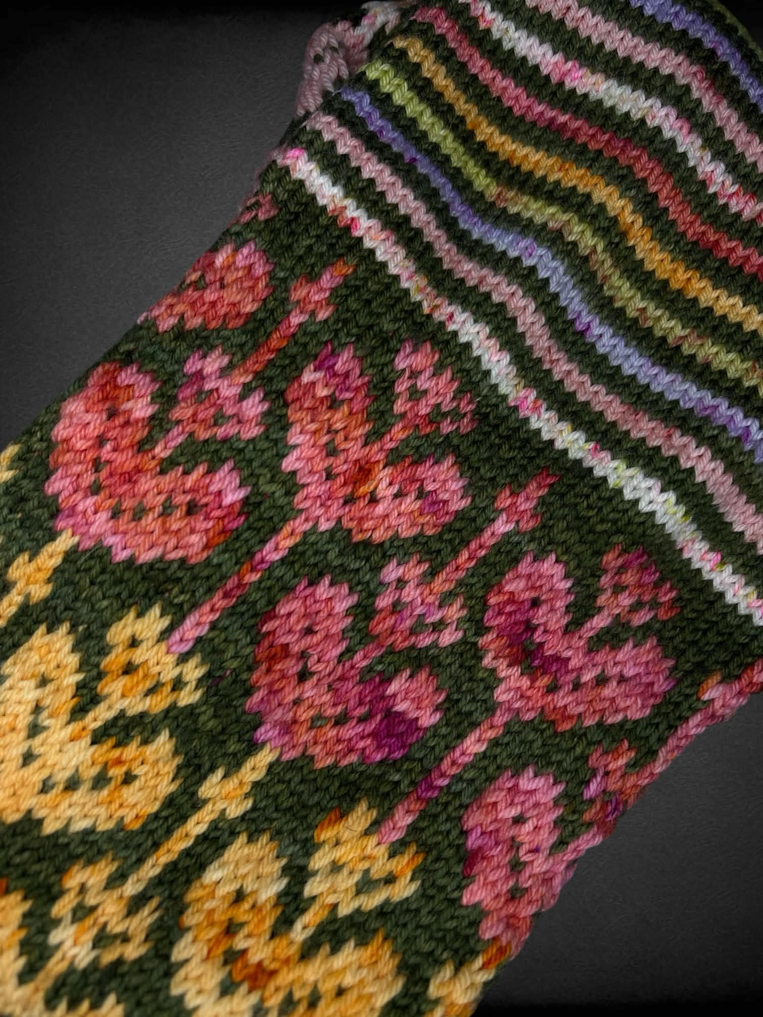 Colorful knit infinity scarf with stripes and flower design