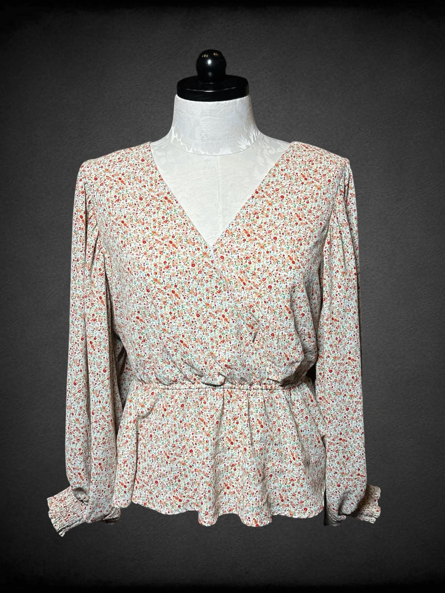0X Arula white flowy top with pink and red floral pattern, and adjustable tie on waist