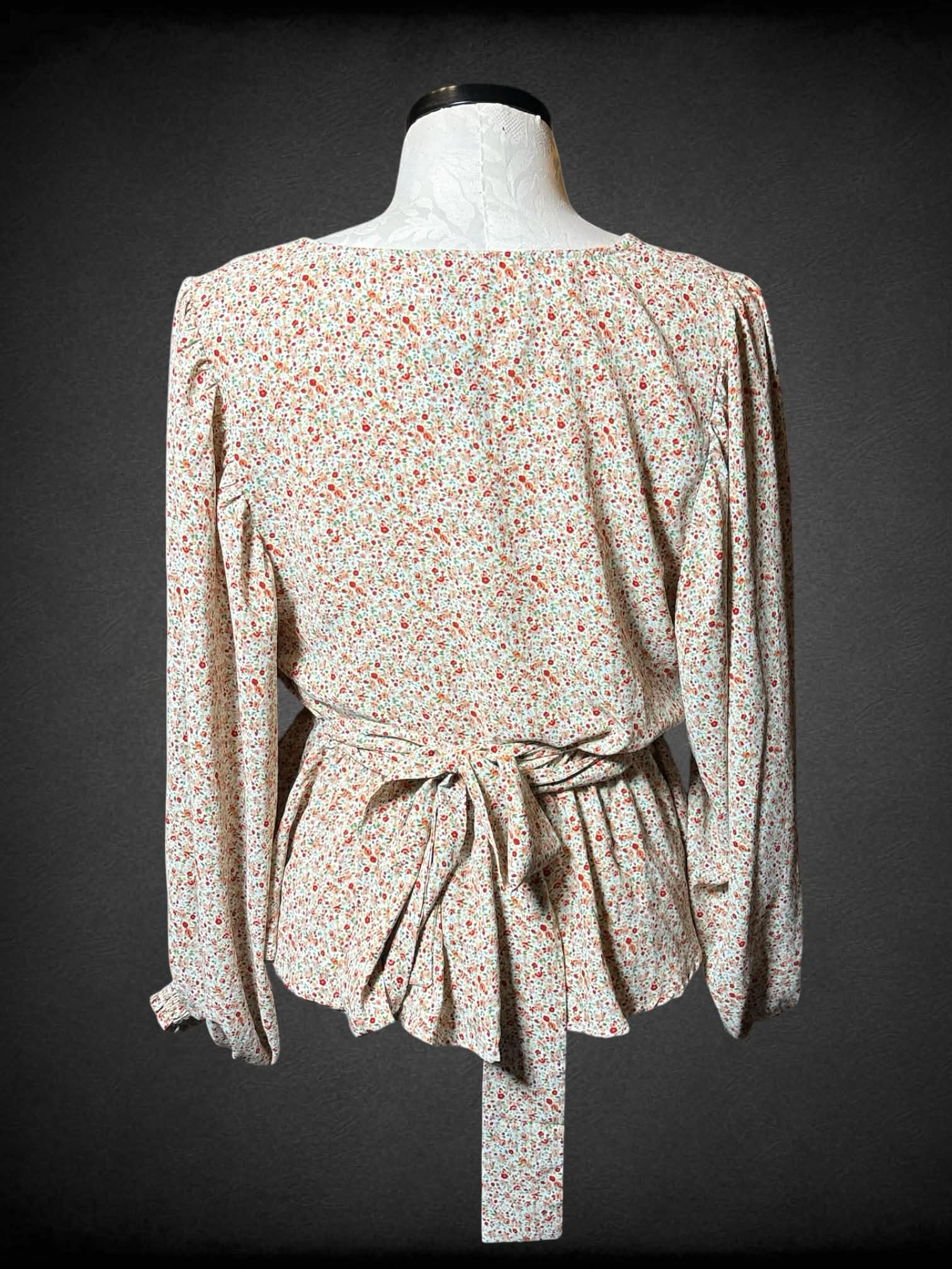 0X Arula white flowy top with pink and red floral pattern, and adjustable tie on waist