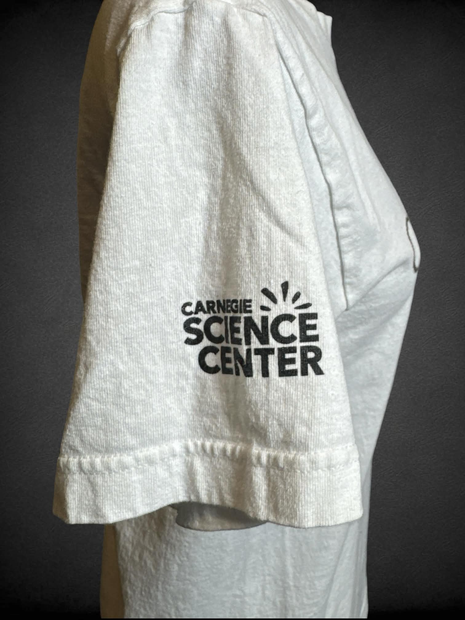 S Cotton Expressions vintage white t shirt with periodic table “caffeine” graphic on front, and “Carnegie Science Center” logo on sleeve